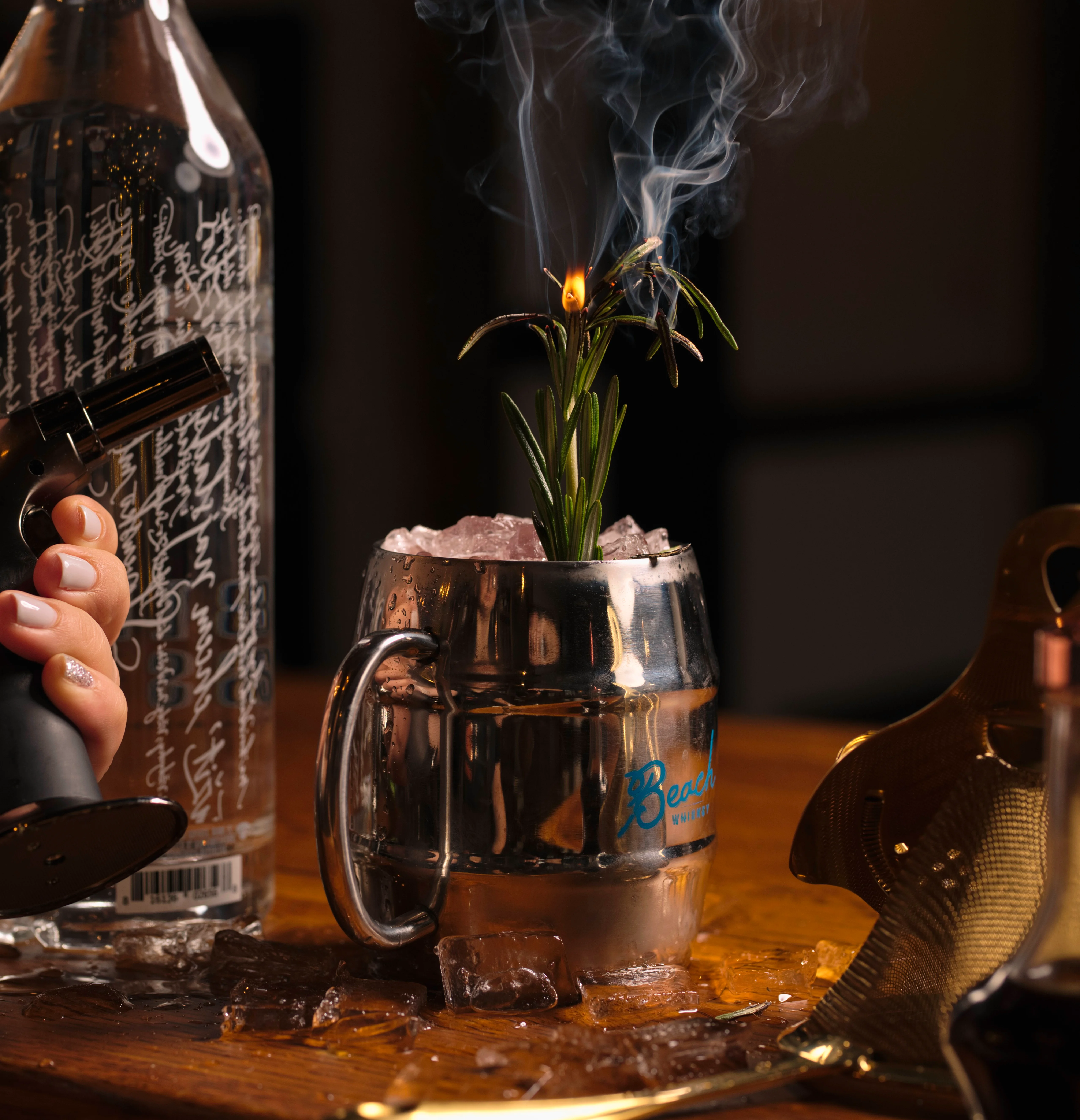 Unique cocktail with smoke and herbs in a metal mug