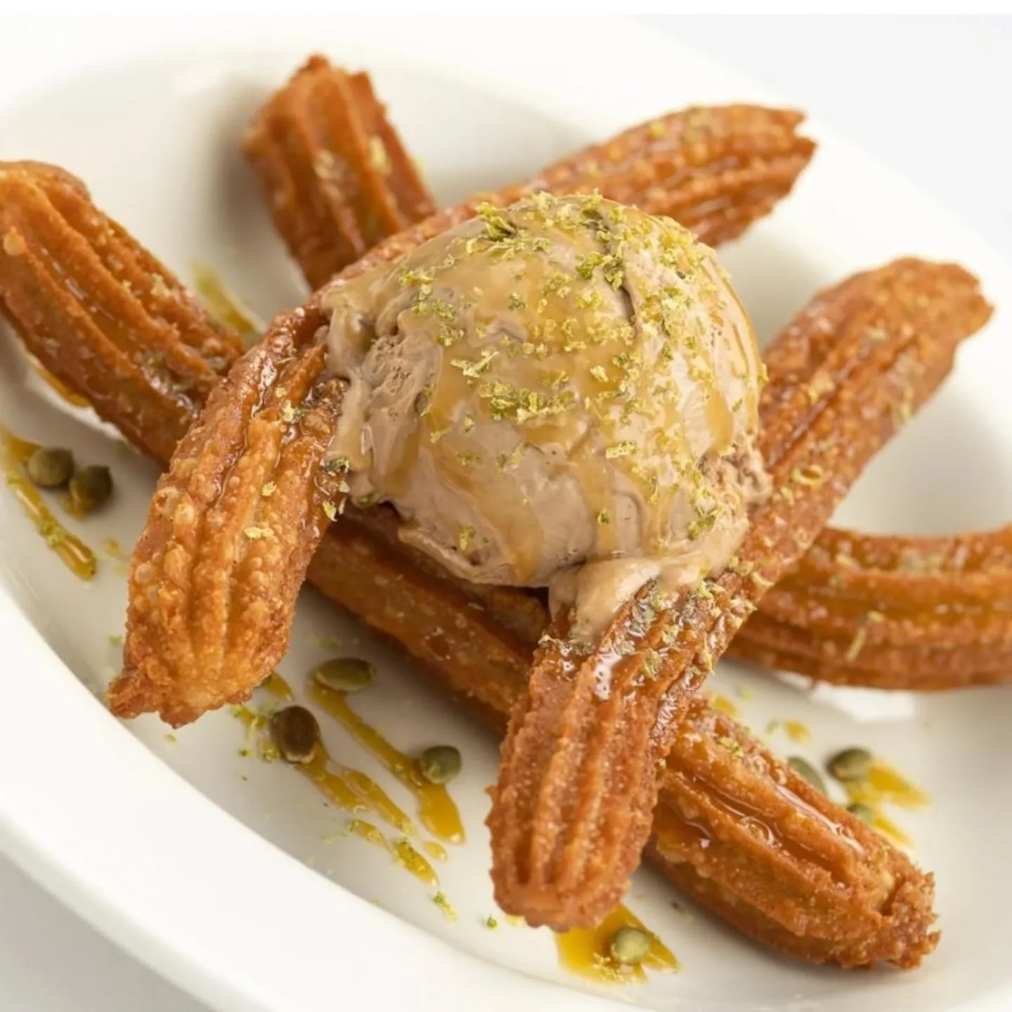 Churros with ice cream and caramel drizzle