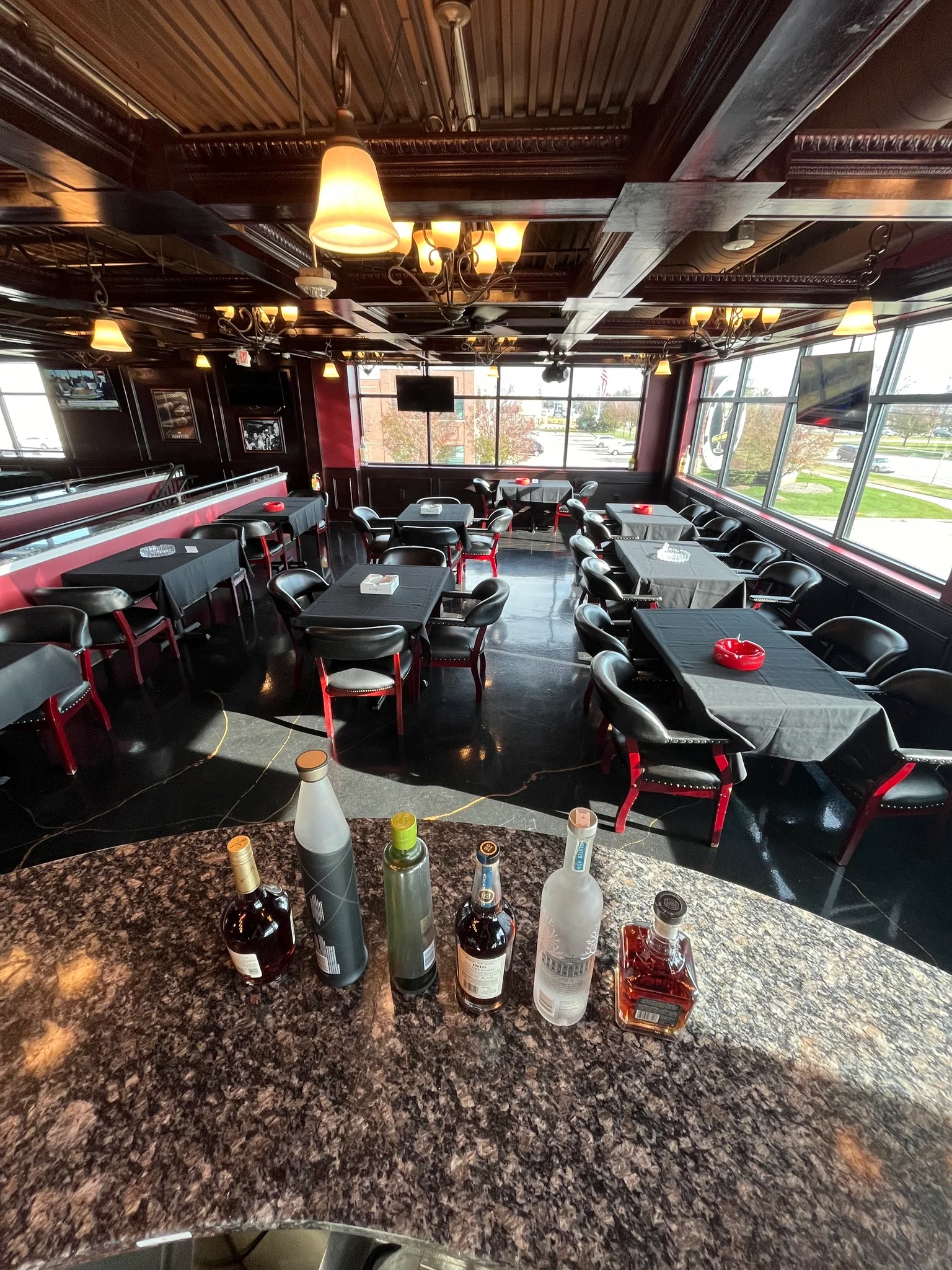 Interior view of a stylish bar with seating and ambient lighting.