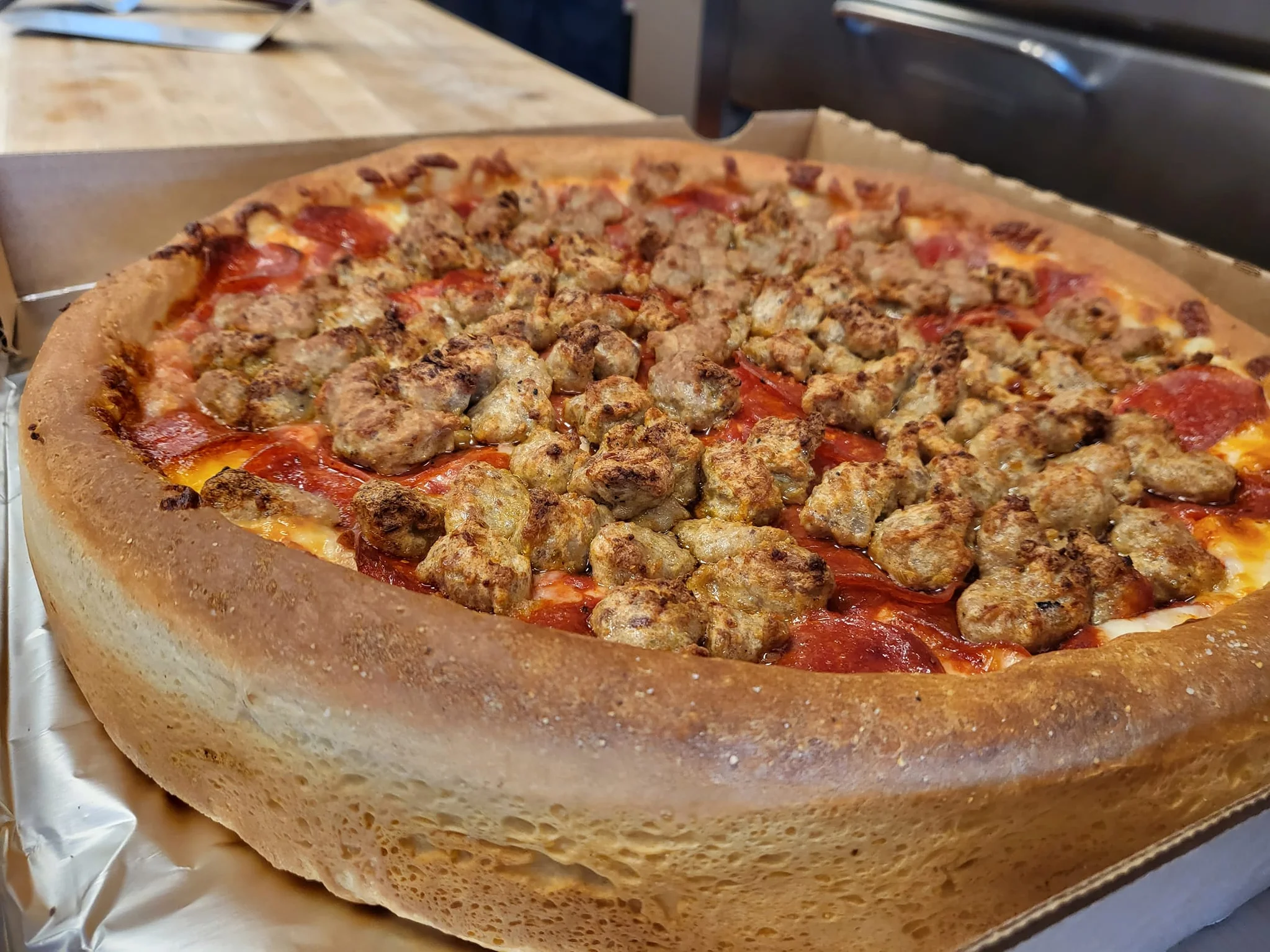 Deep-dish pizza topped with sausage and pepperoni