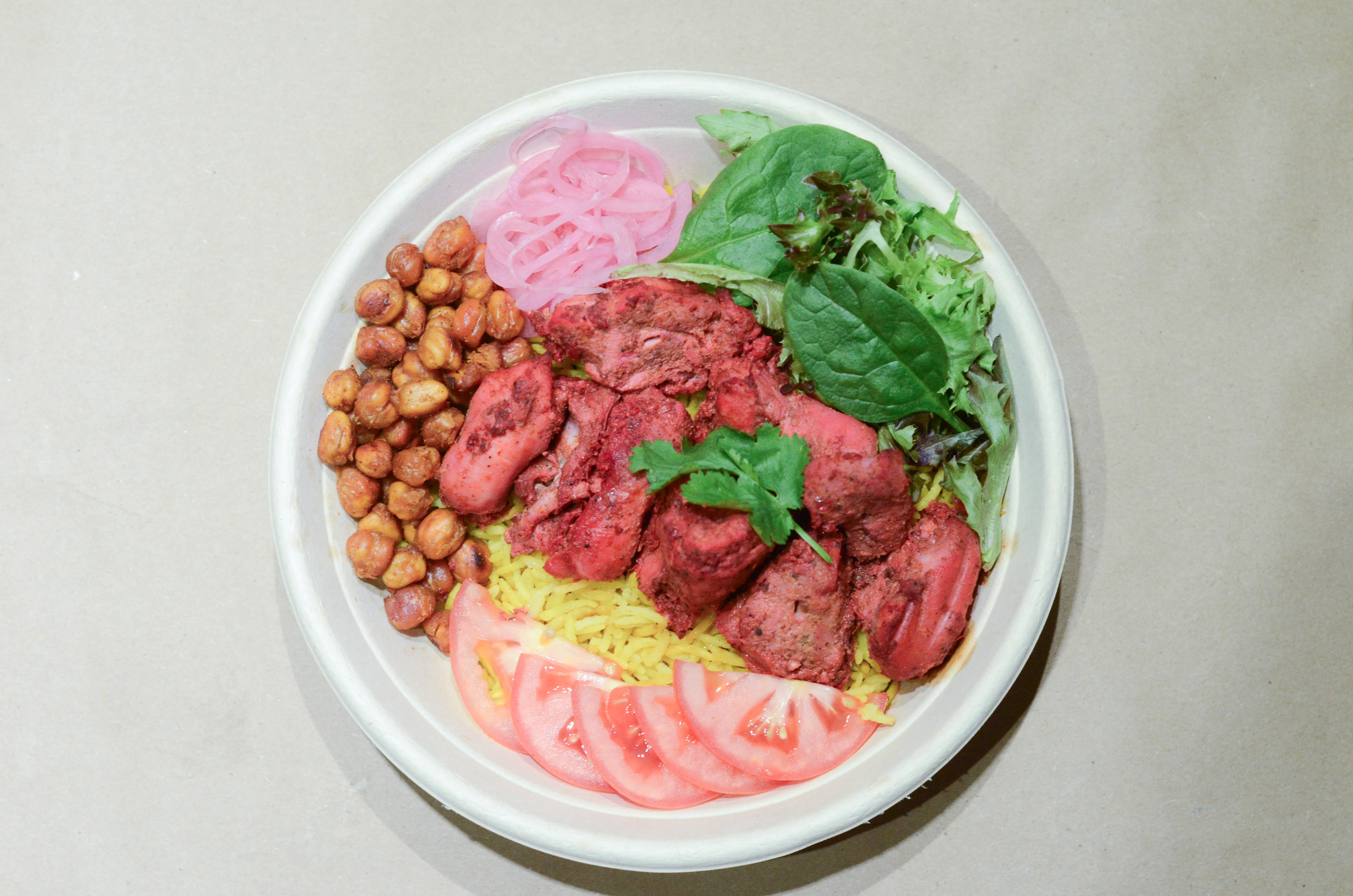 Flavorful Indian chicken biryani bowl with vibrant toppings