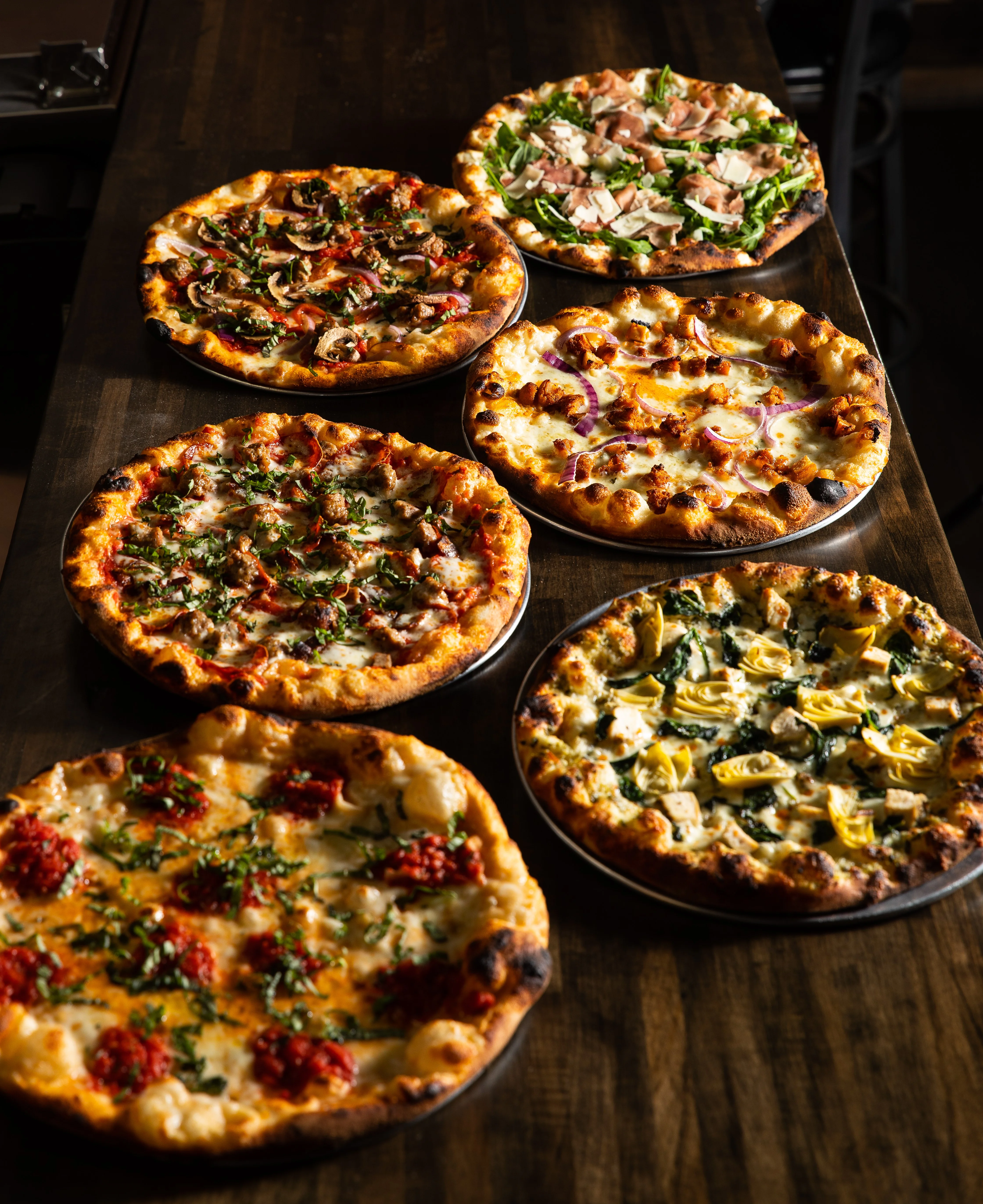 A line up of speciality pizzas by Big Pauly's