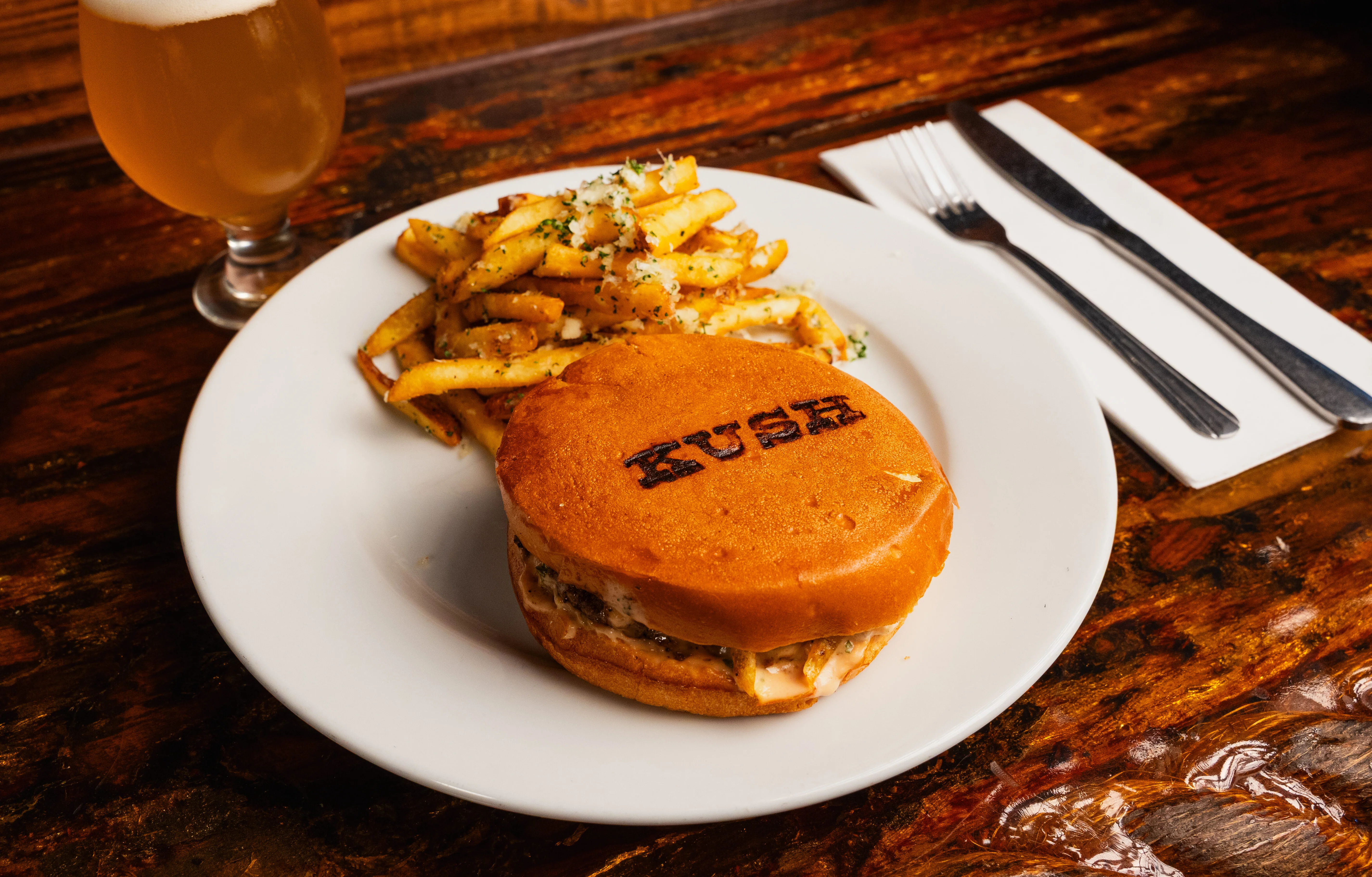 Gourmet burger with fries in a rustic setting