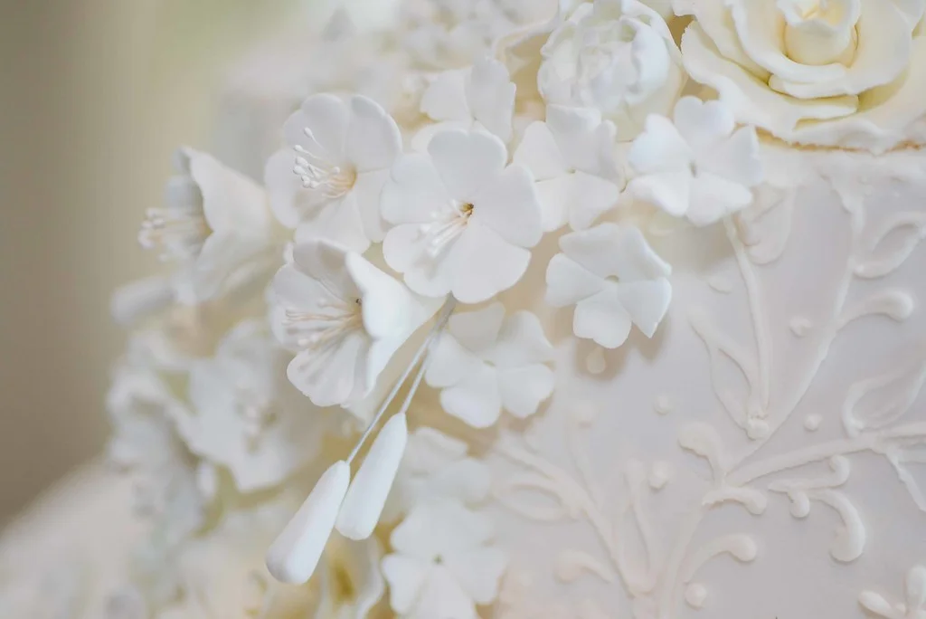 Elegant white floral cake decoration with intricate details
