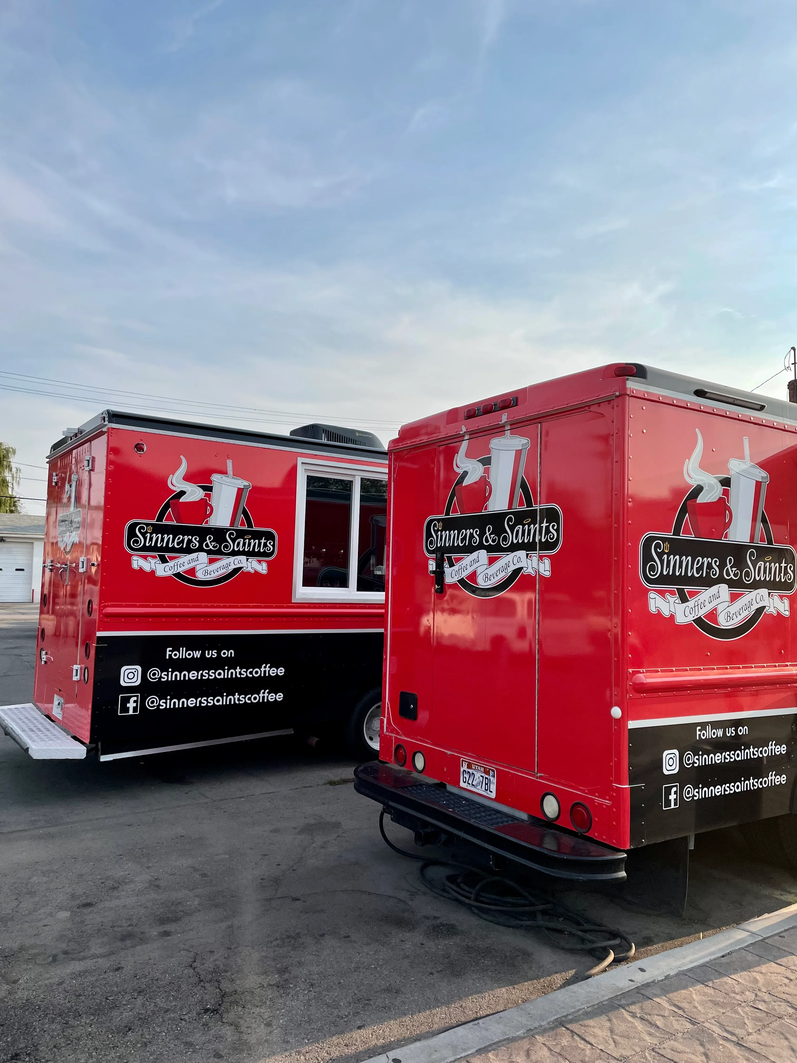Two red food trucks for Sinners & Saints Coffee