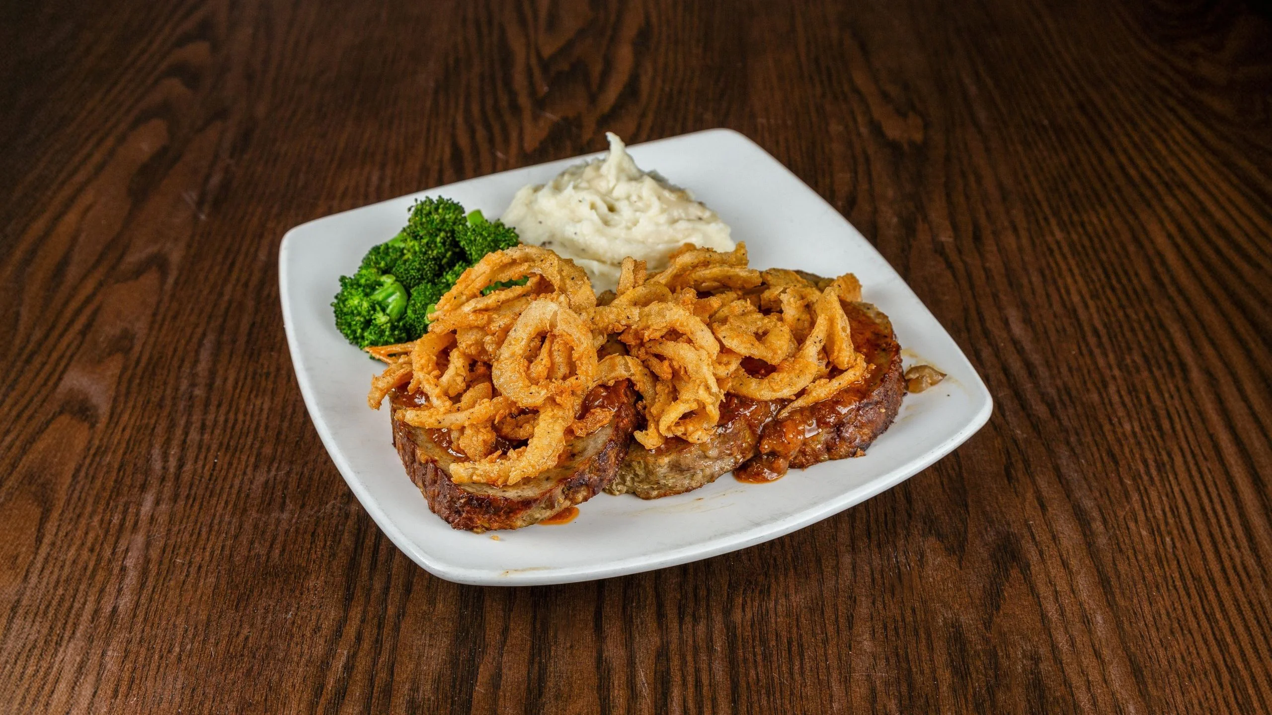 Classic American meatloaf topped with crispy onion rings