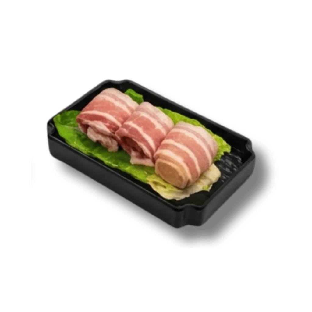 Three pieces of rolled bacon on lettuce in a black tray.