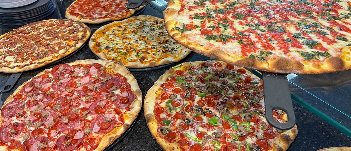Variety of gourmet pizzas on display in a restaurant
