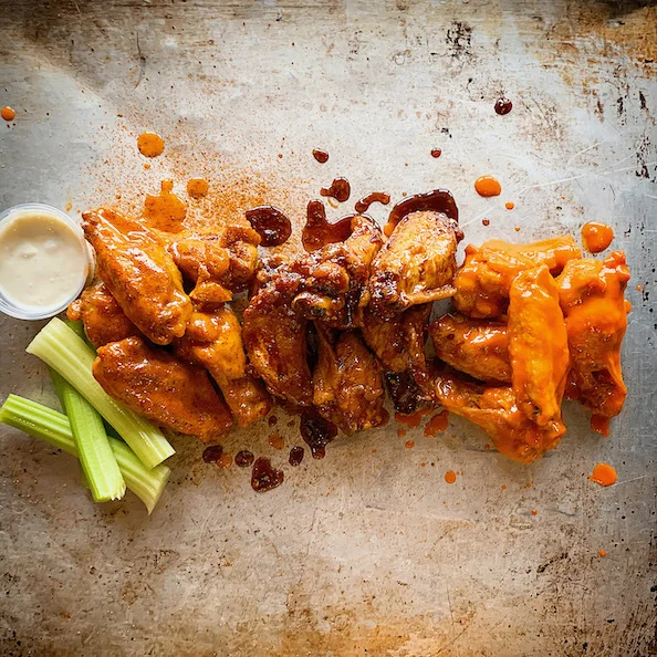 Buffalo chicken wings with celery and dipping sauce