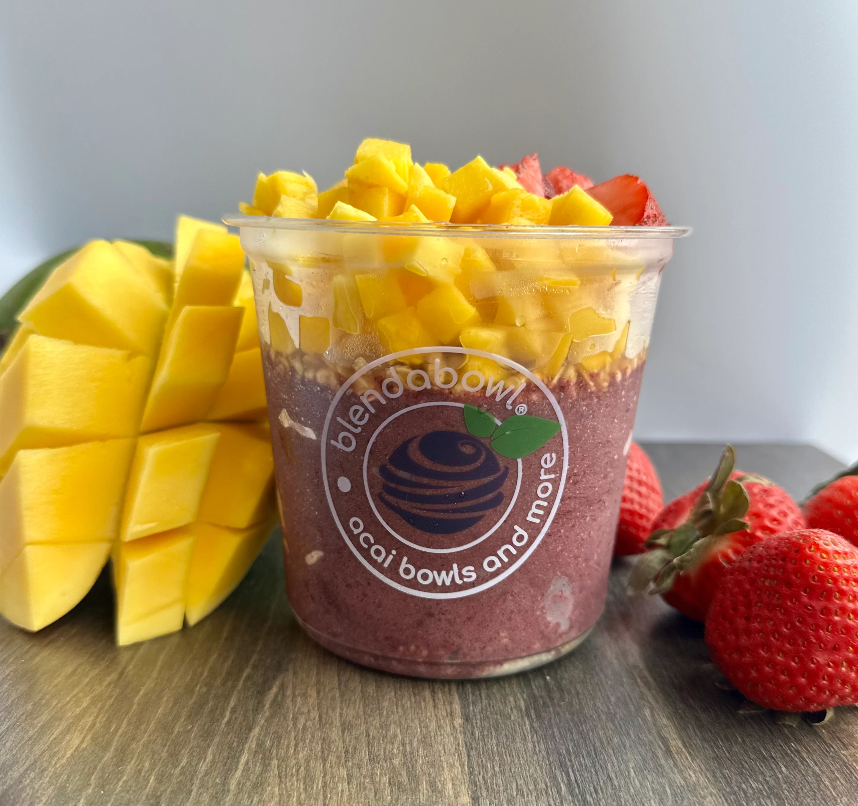 A vibrant Acai bowl topped with fresh strawberries and Mango