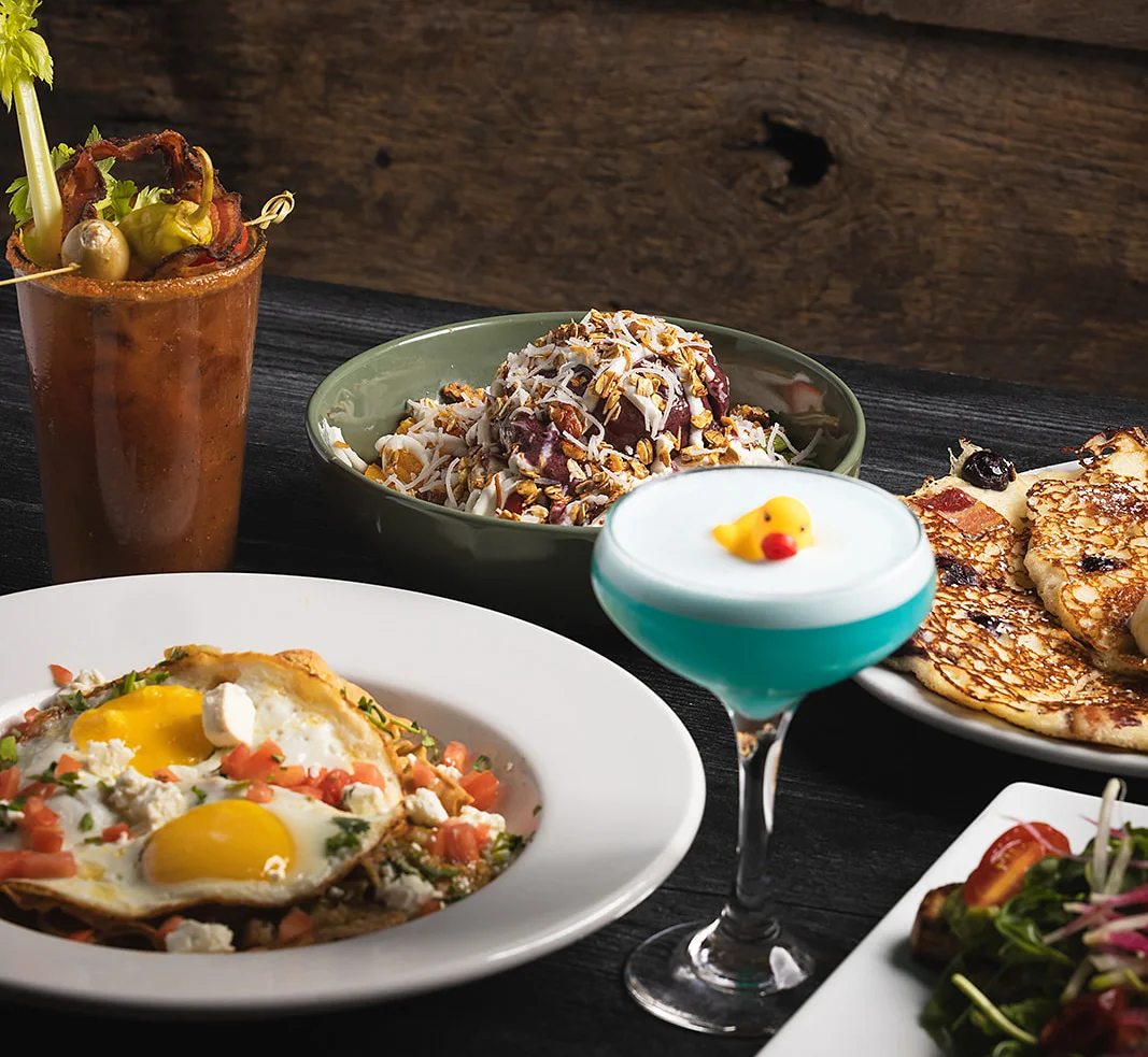 Colorful brunch spread featuring huevos rancheros and creative cocktails