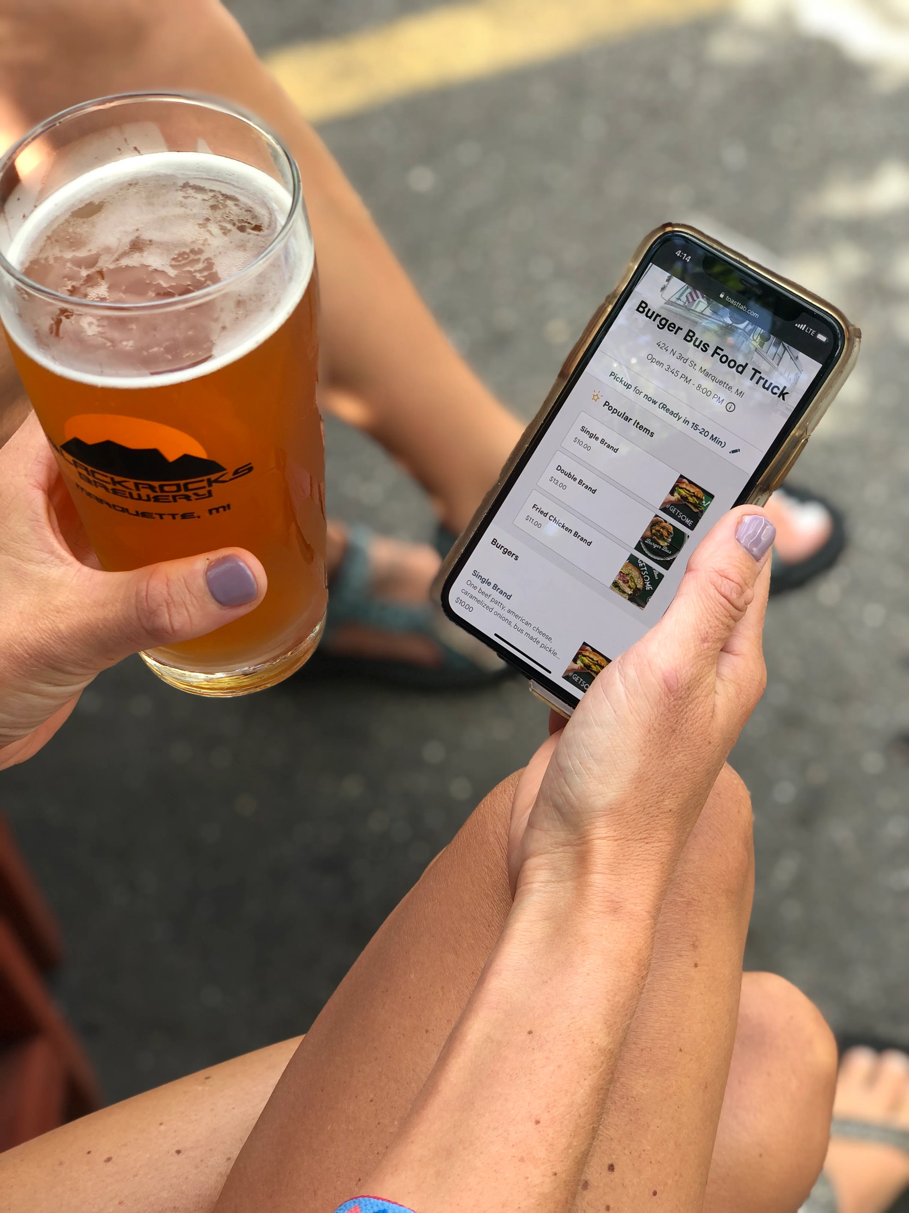 Enjoying a craft beer while browsing a food truck menu