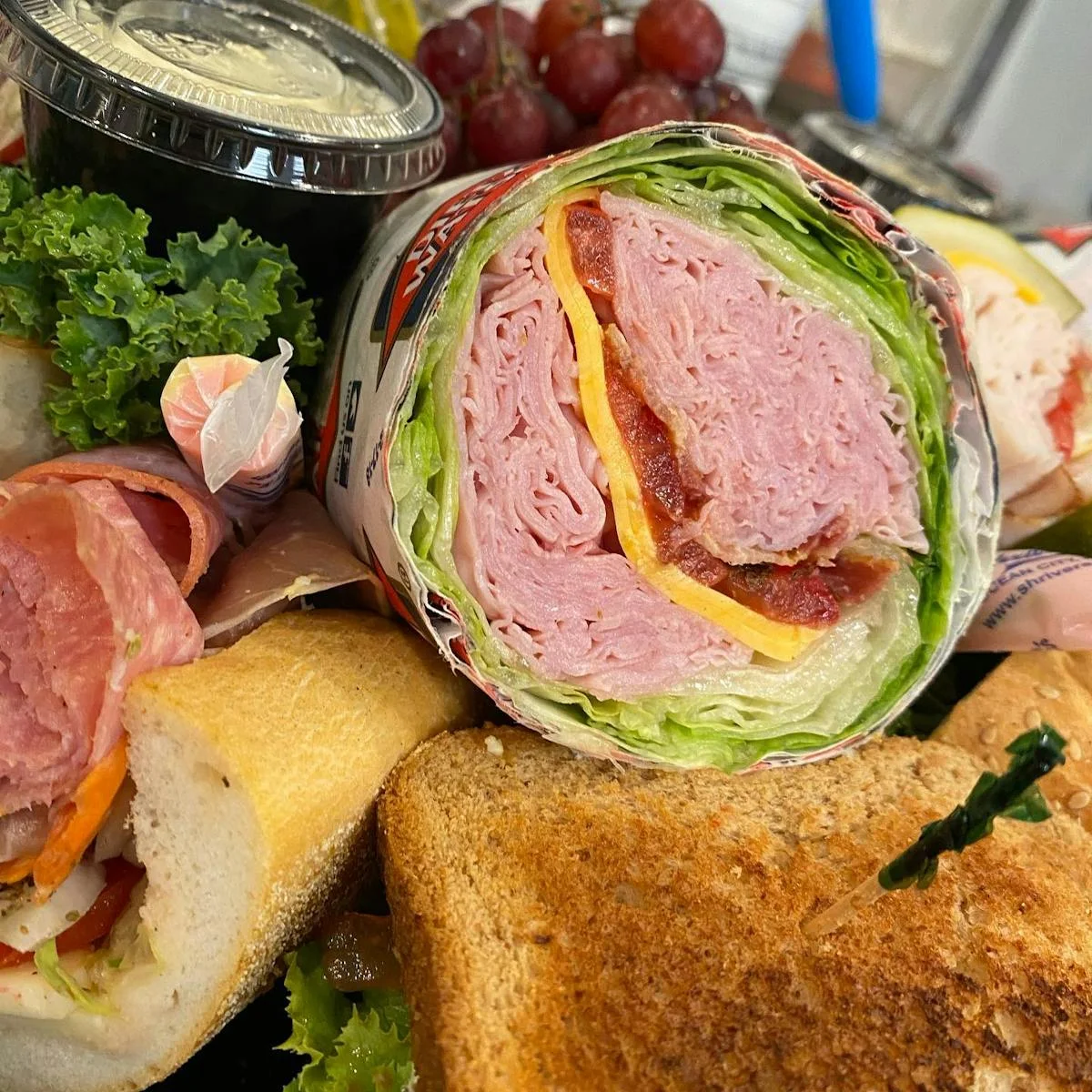 Italian deli sandwich with layers of meats and fresh greens
