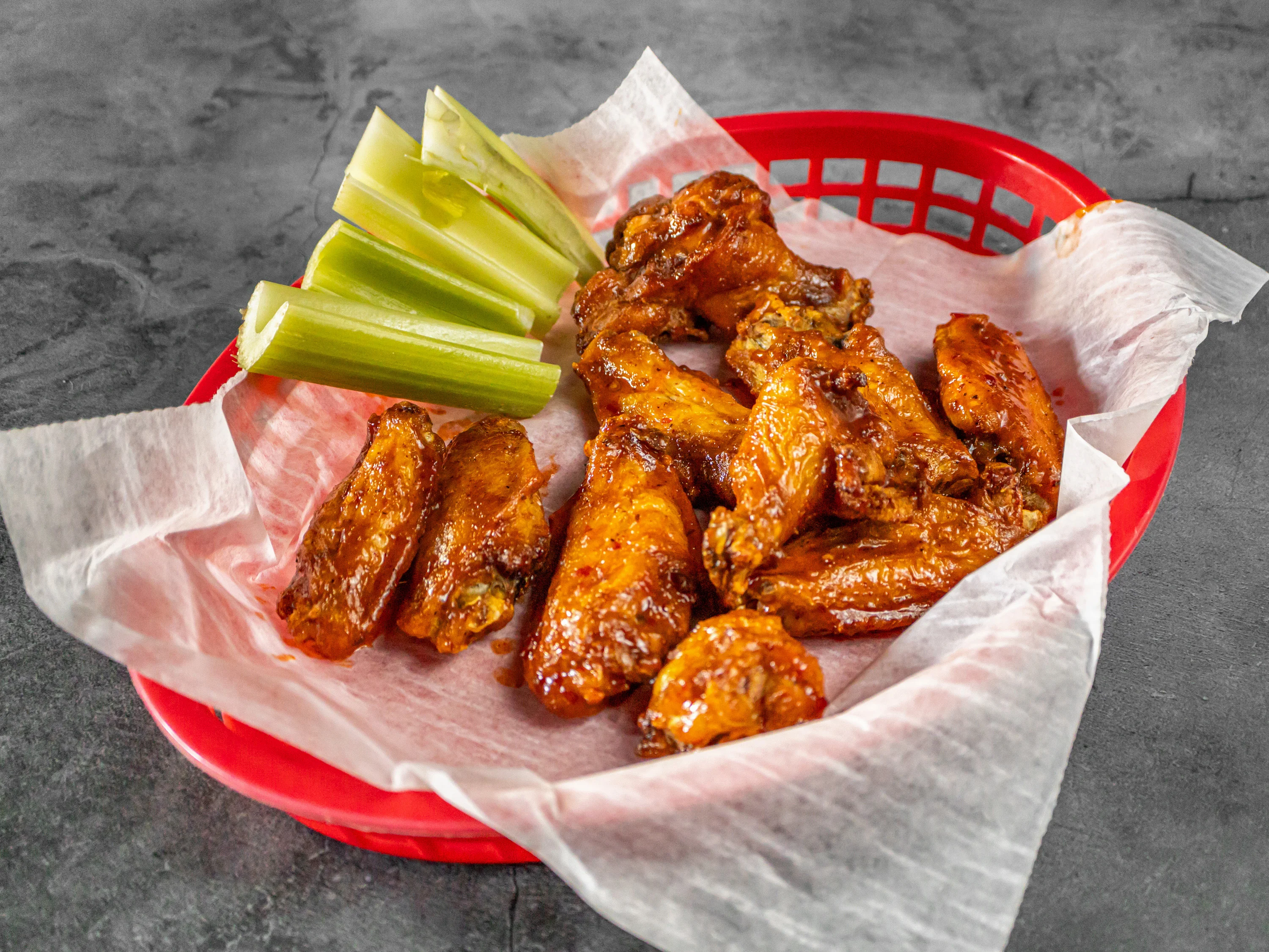 Crispy buffalo chicken wings with celery sticks