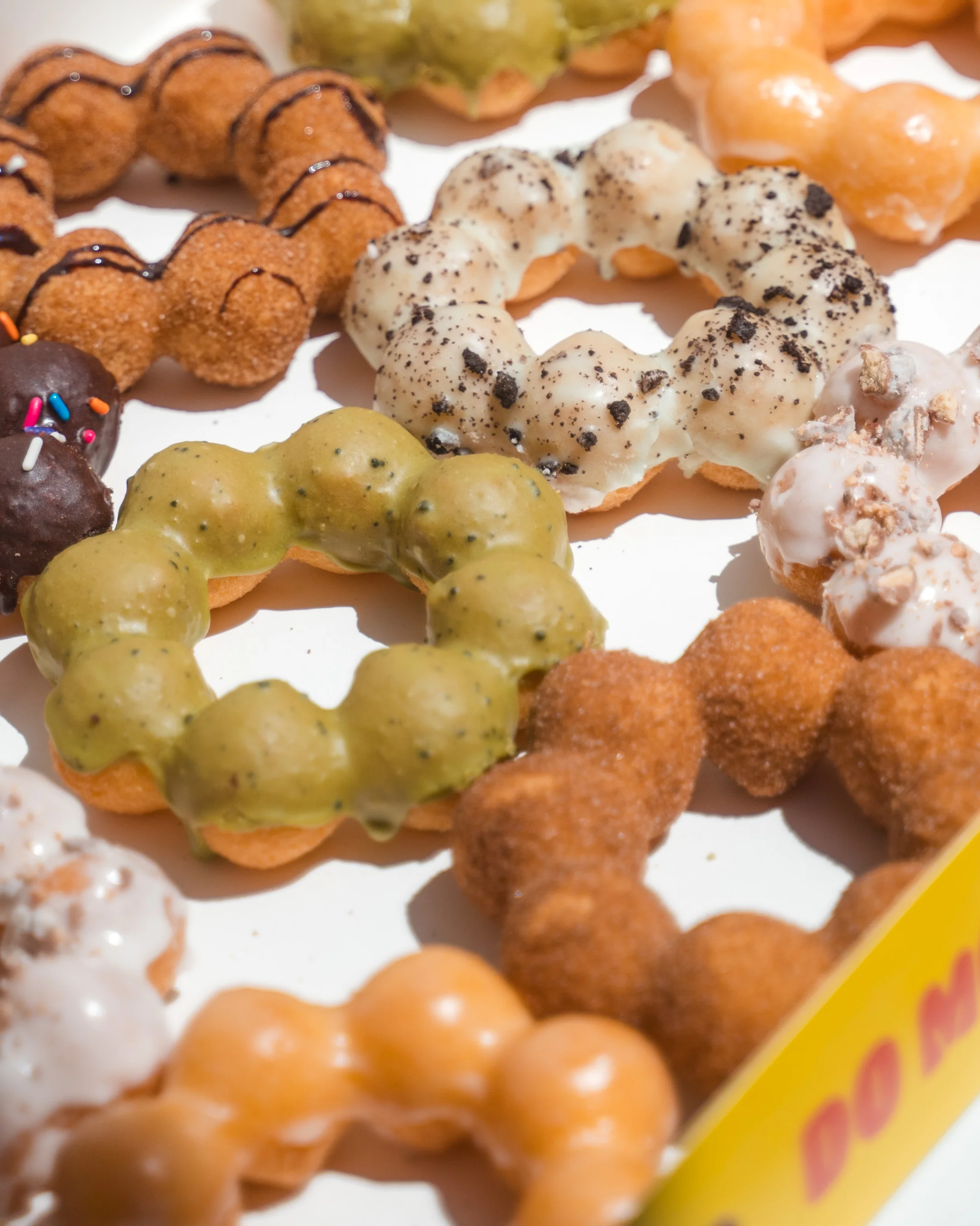 Assorted Japanese mochi donuts in a colorful box
