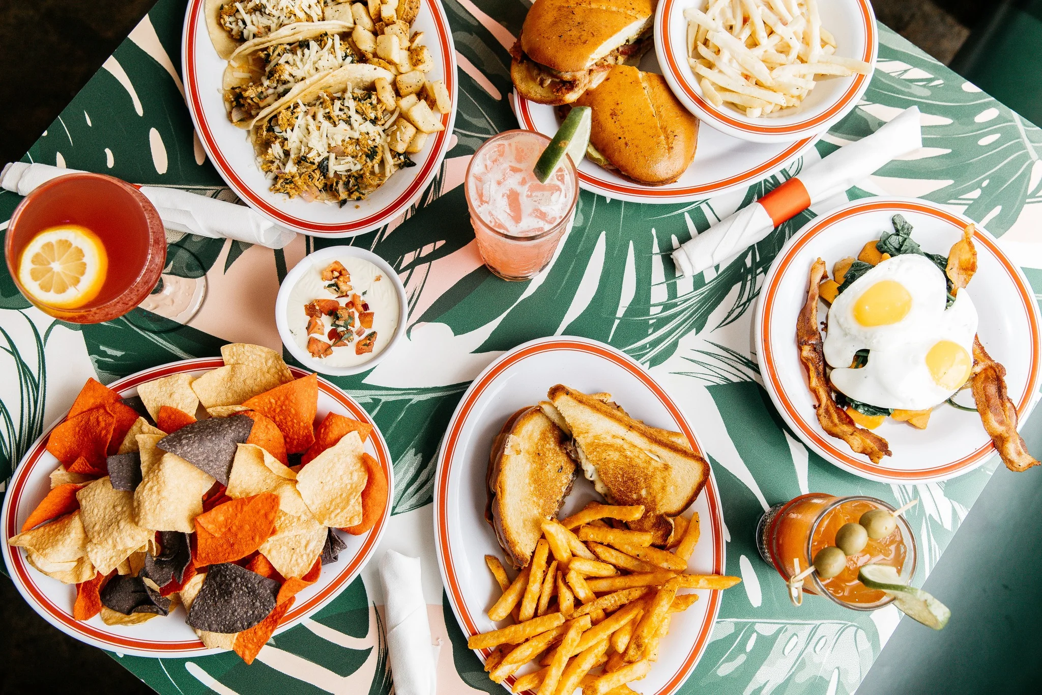 Colorful brunch spread featuring tacos and sandwiches