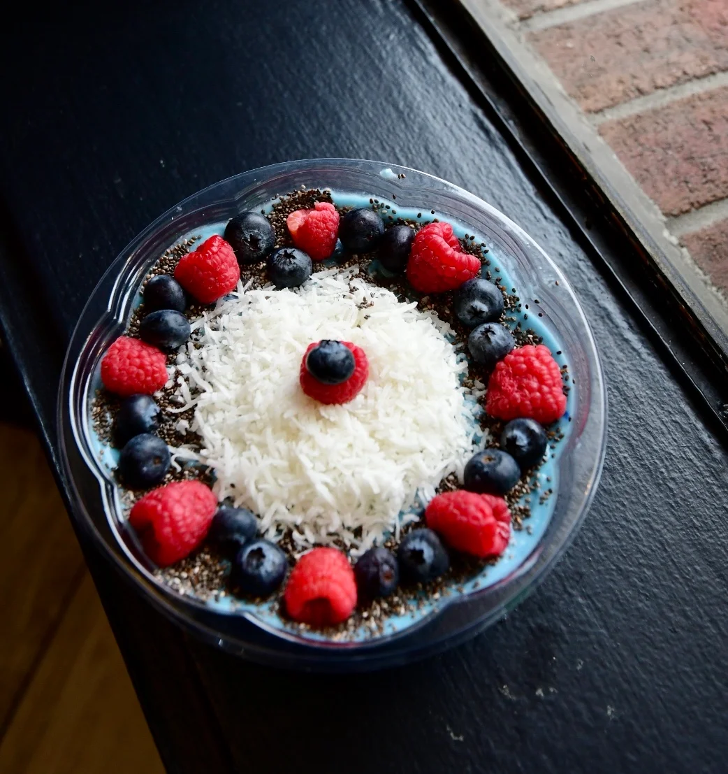 Colorful acai bowl topped with berries and coconut