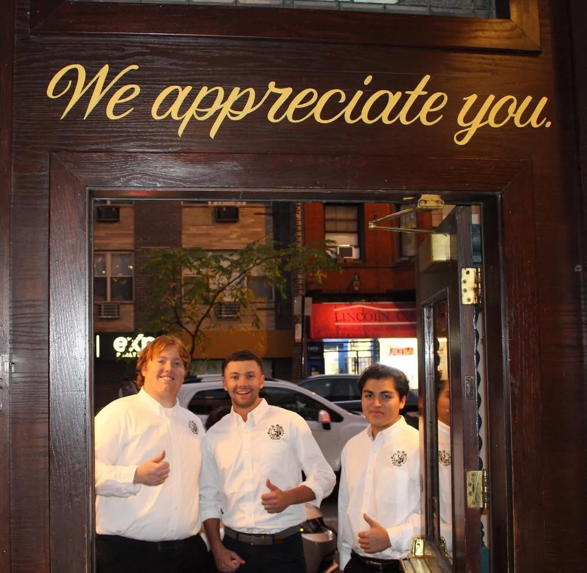 Friendly restaurant staff welcoming guests at the entrance