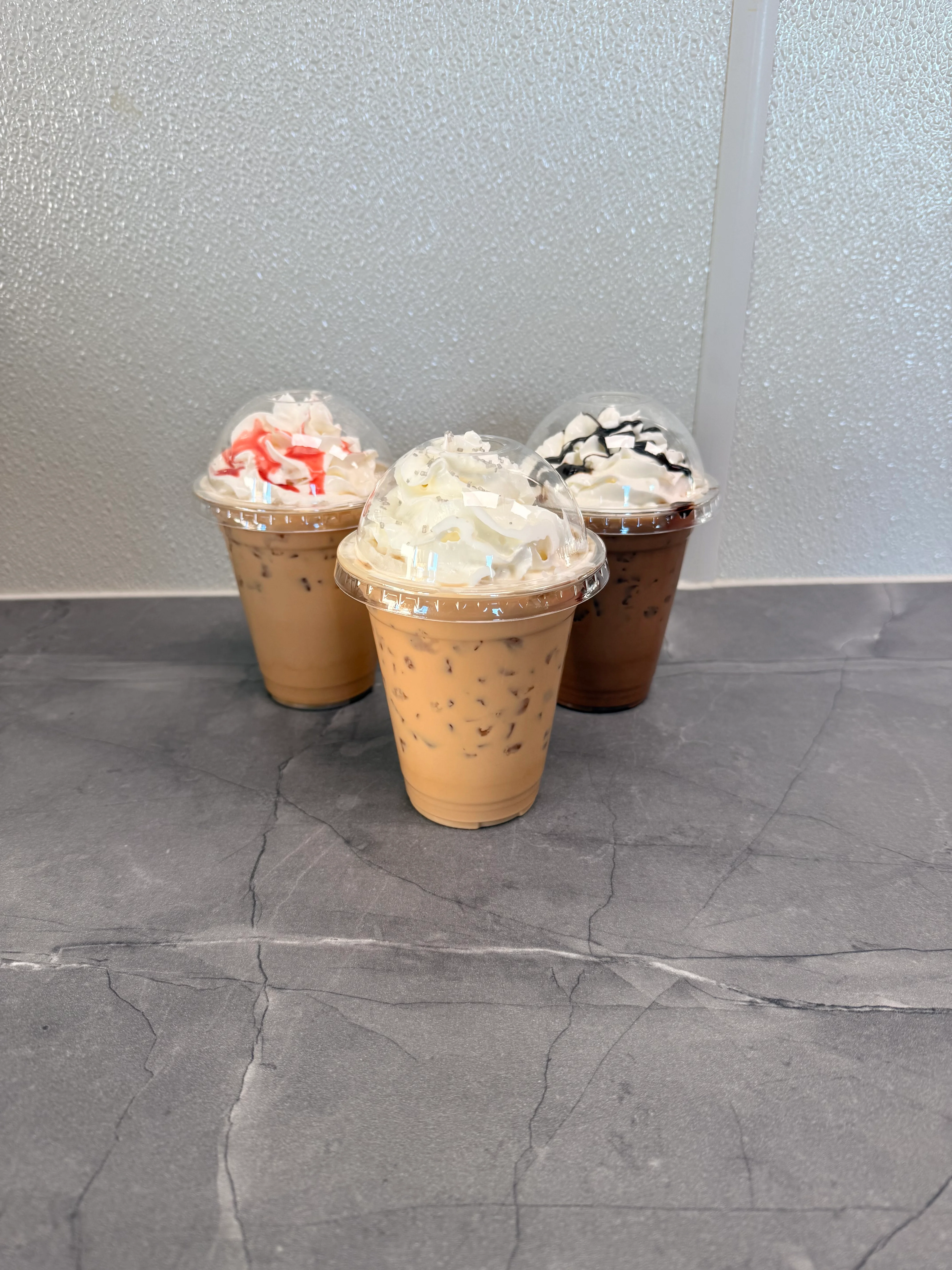 Iced coffee drinks topped with whipped cream