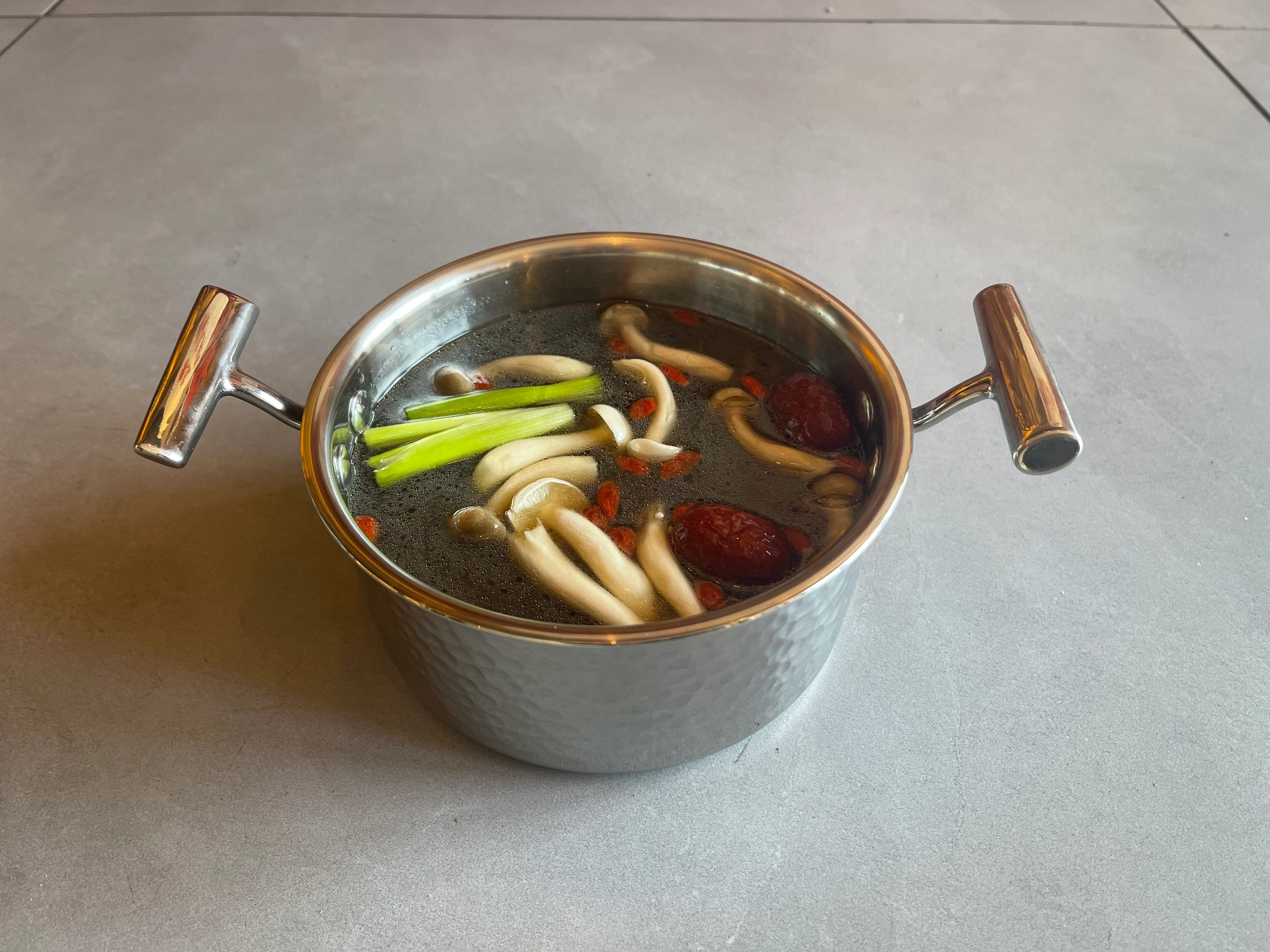 Chinese herbal soup with mushrooms and goji berries