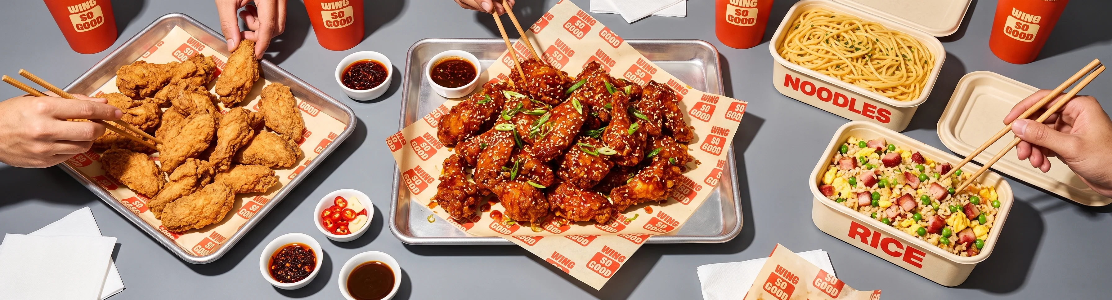 Korean fried chicken with noodles and rice in takeout containers