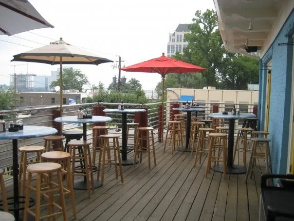 Outdoor dining area with tables and umbrellas