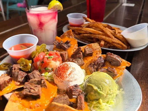 Loaded nachos with guacamole, sour cream, queso, salsa, and tortilla chips
