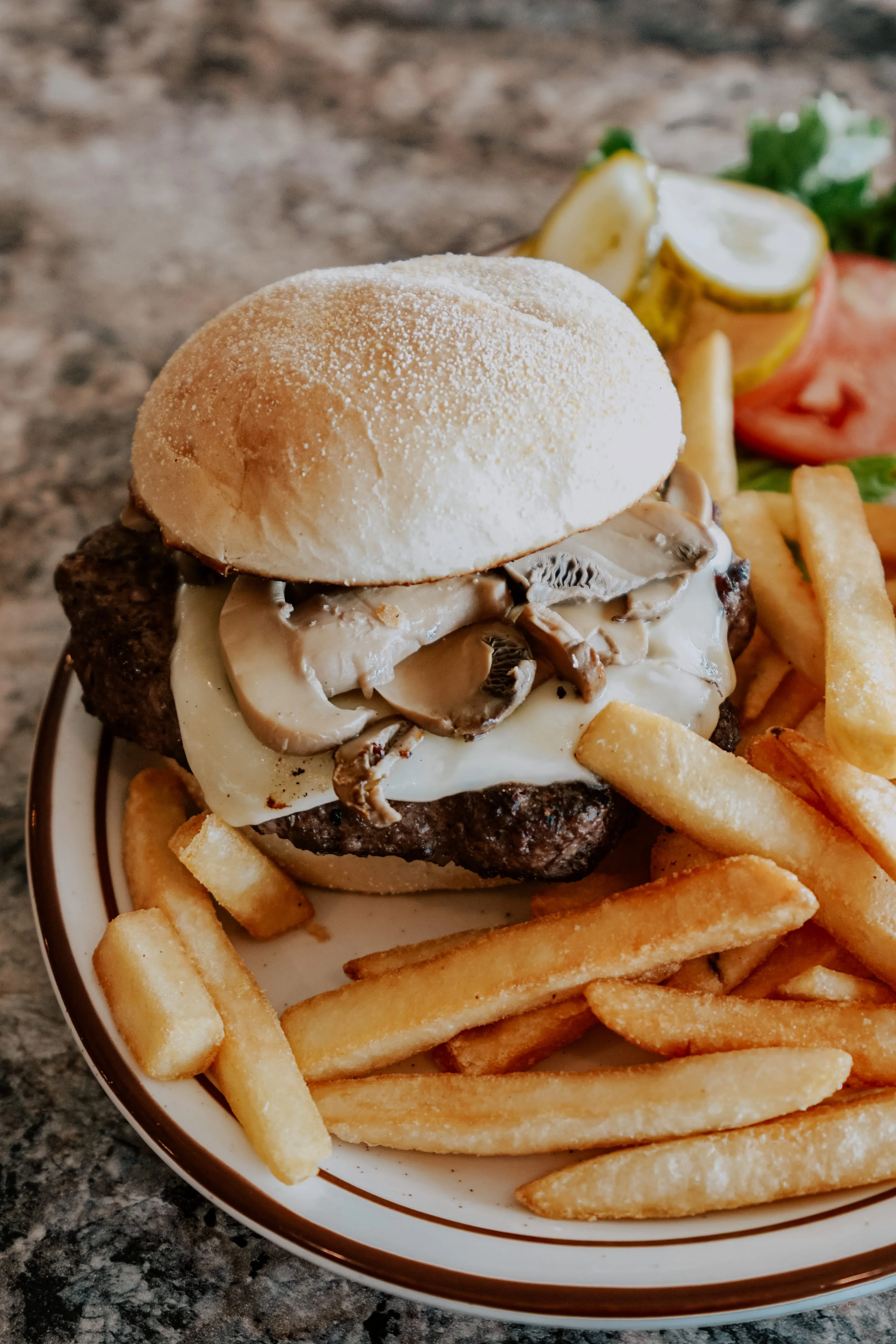 Juicy cheeseburger with mushrooms and fries