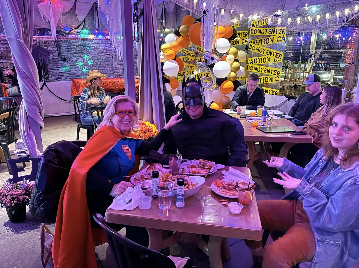 Festive Halloween dining with superhero costumes and delicious food
