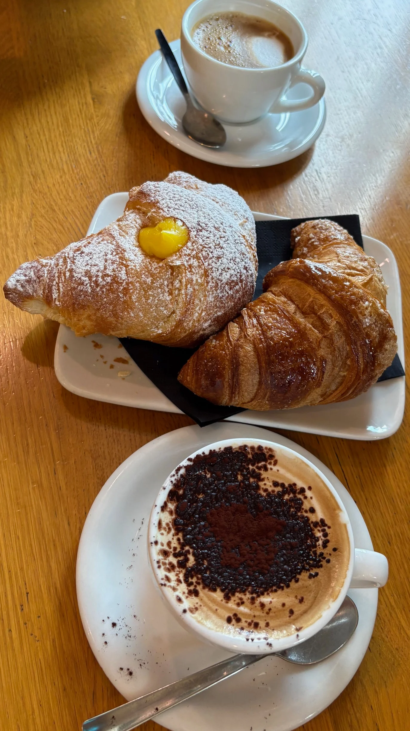 Freshly baked croissants and cappuccino in a cozy café setting
