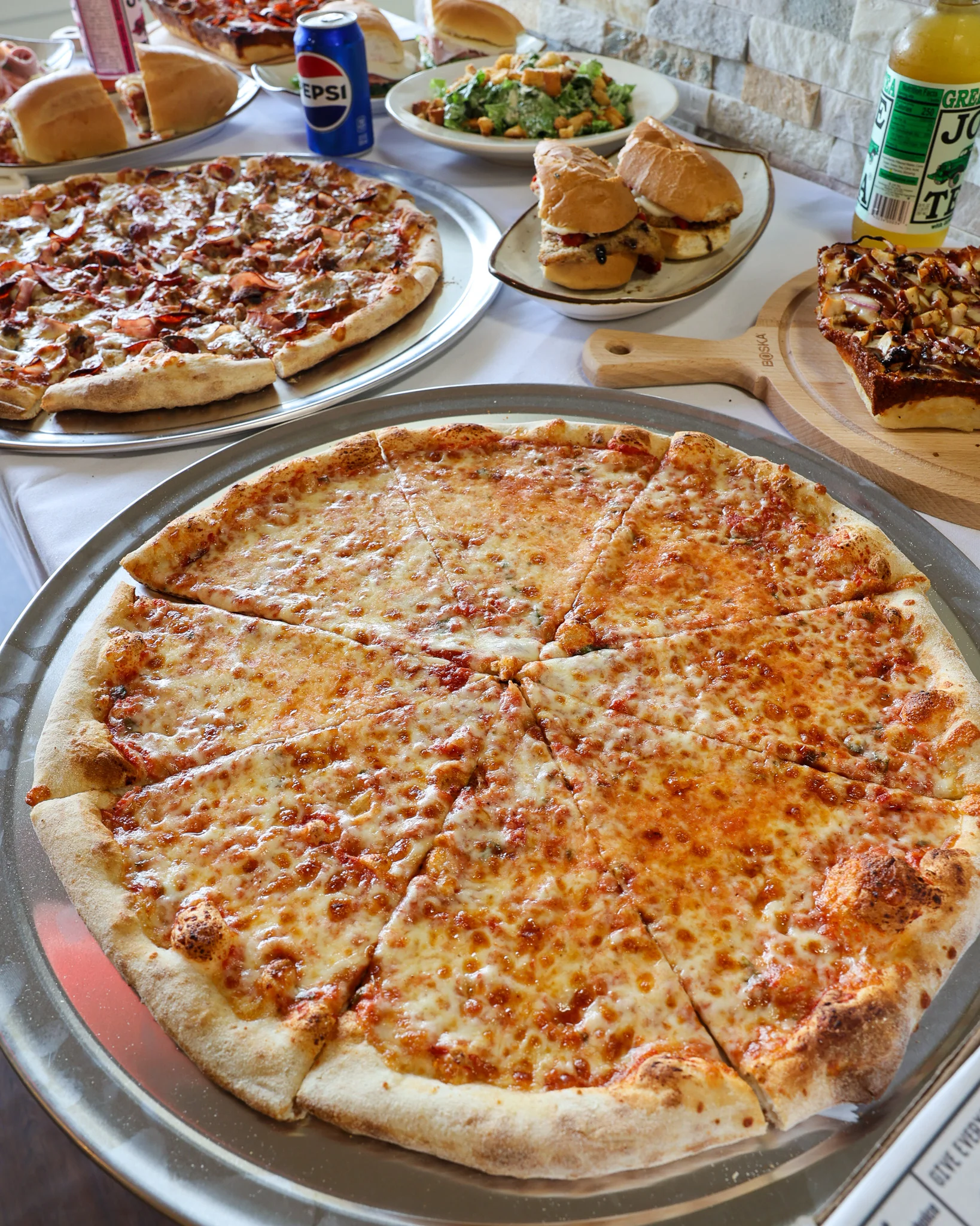 Cheese pizza served on a silver platter