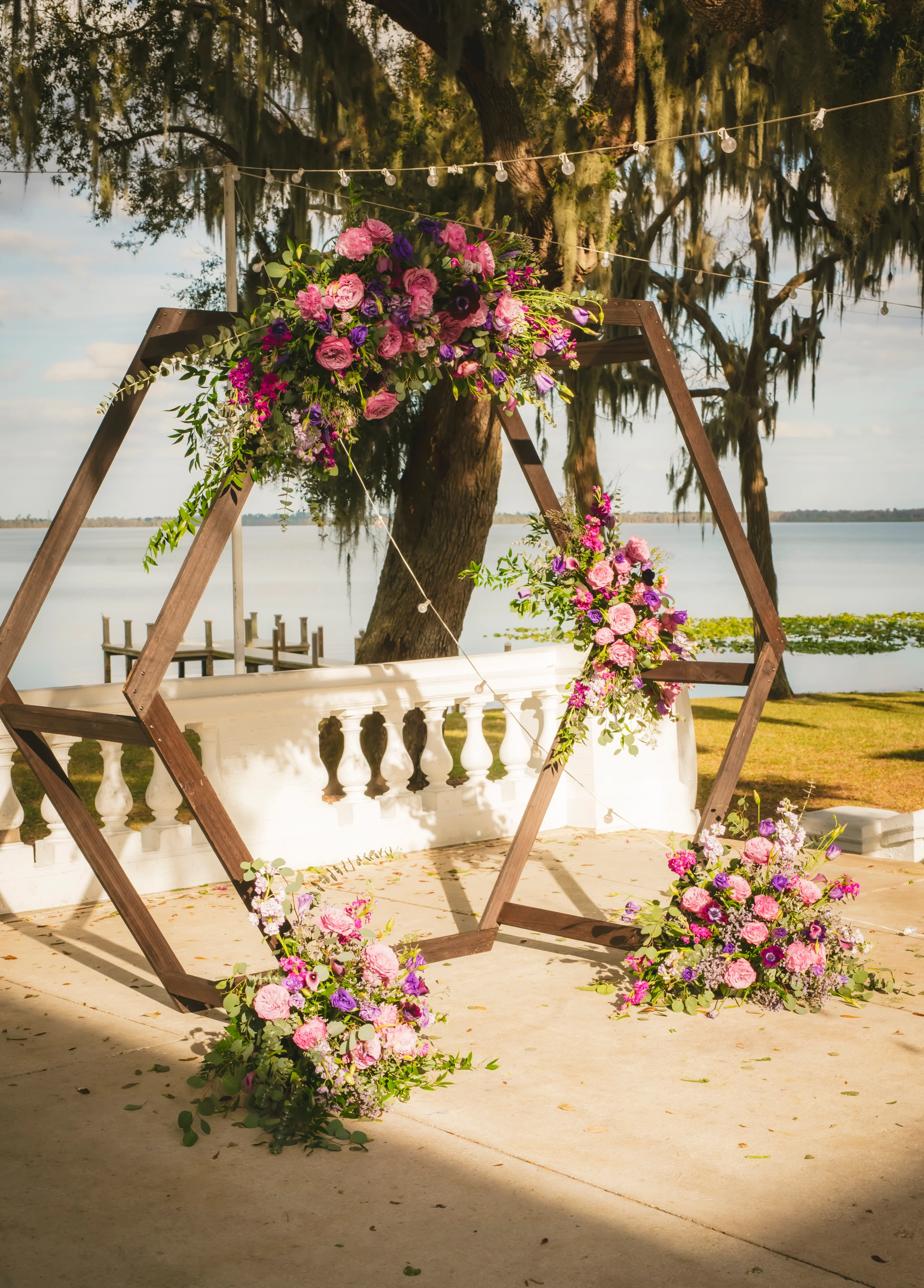 Beautiful floral wedding arch by the lake
