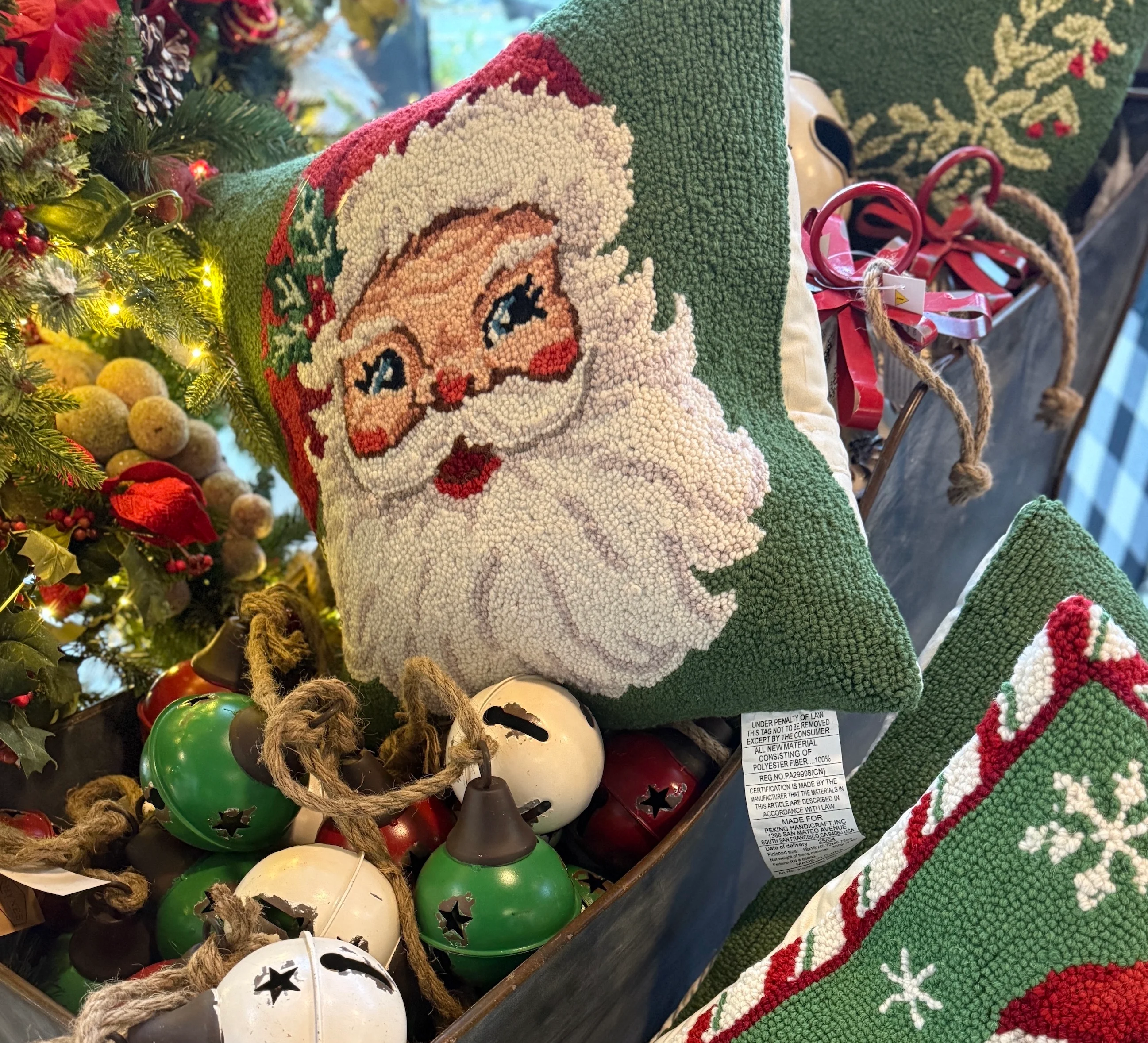 Festive holiday decor with Santa-themed pillow and jingle bells