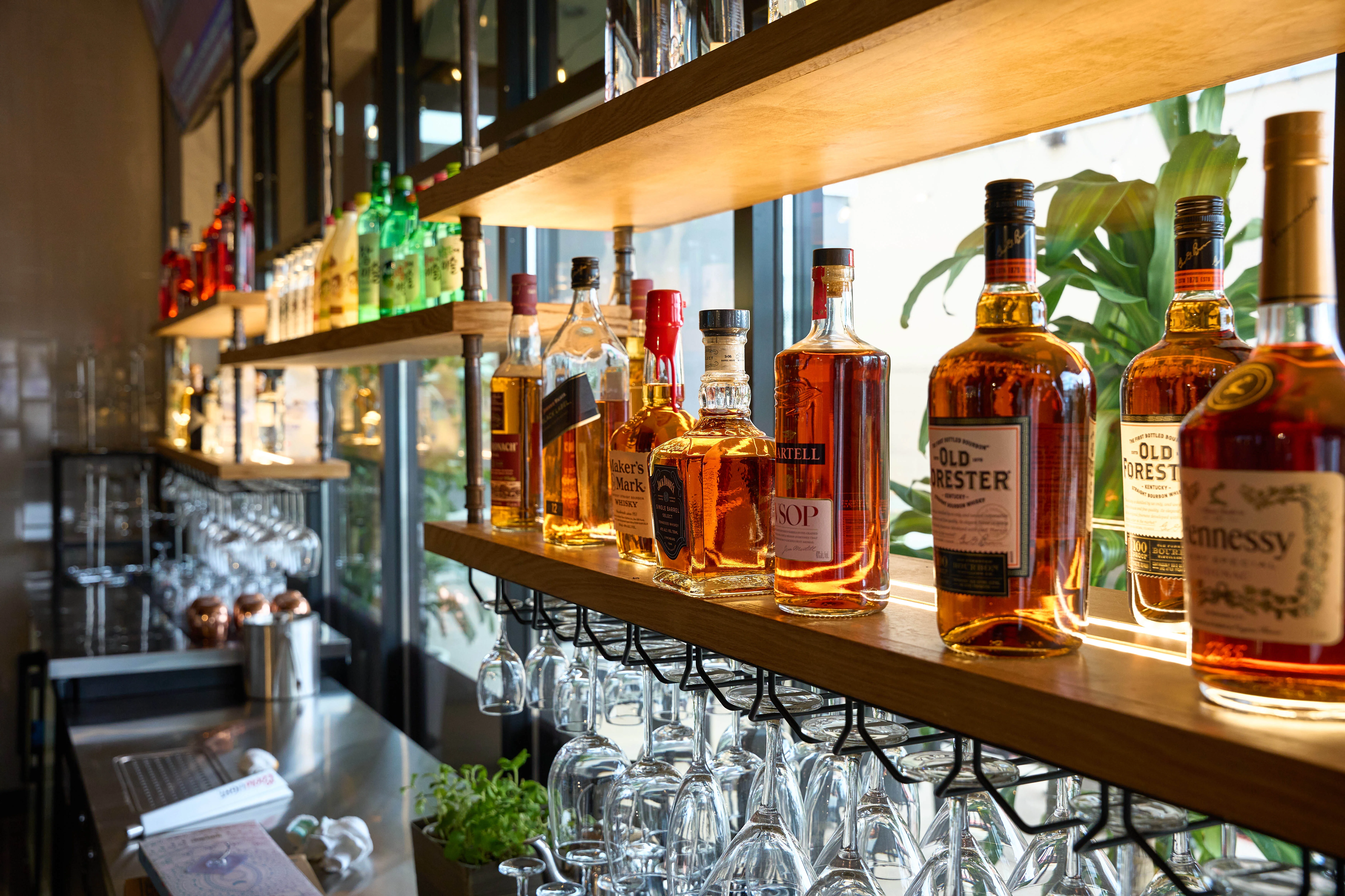 Well-stocked bar shelf with various spirits and liquors
