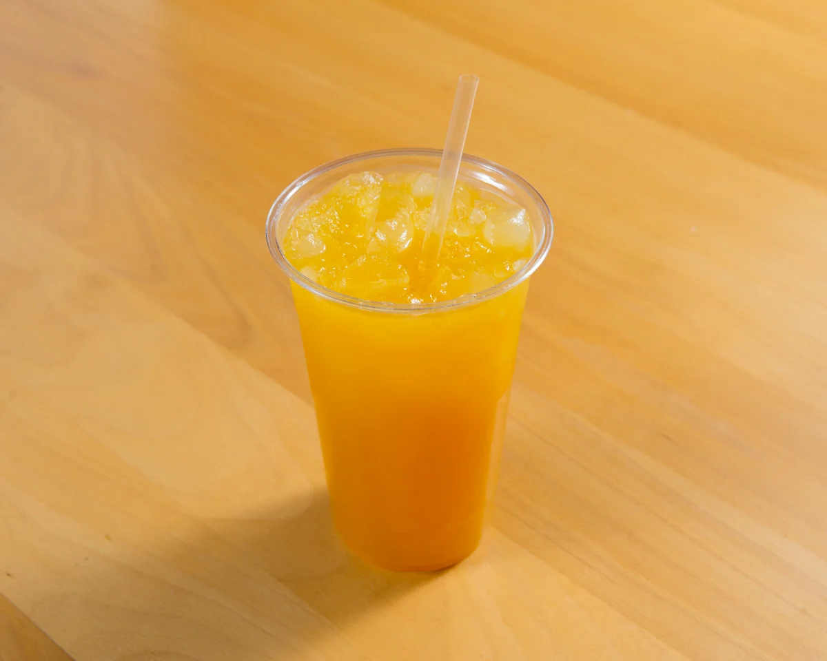 Refreshing glass of orange juice with ice