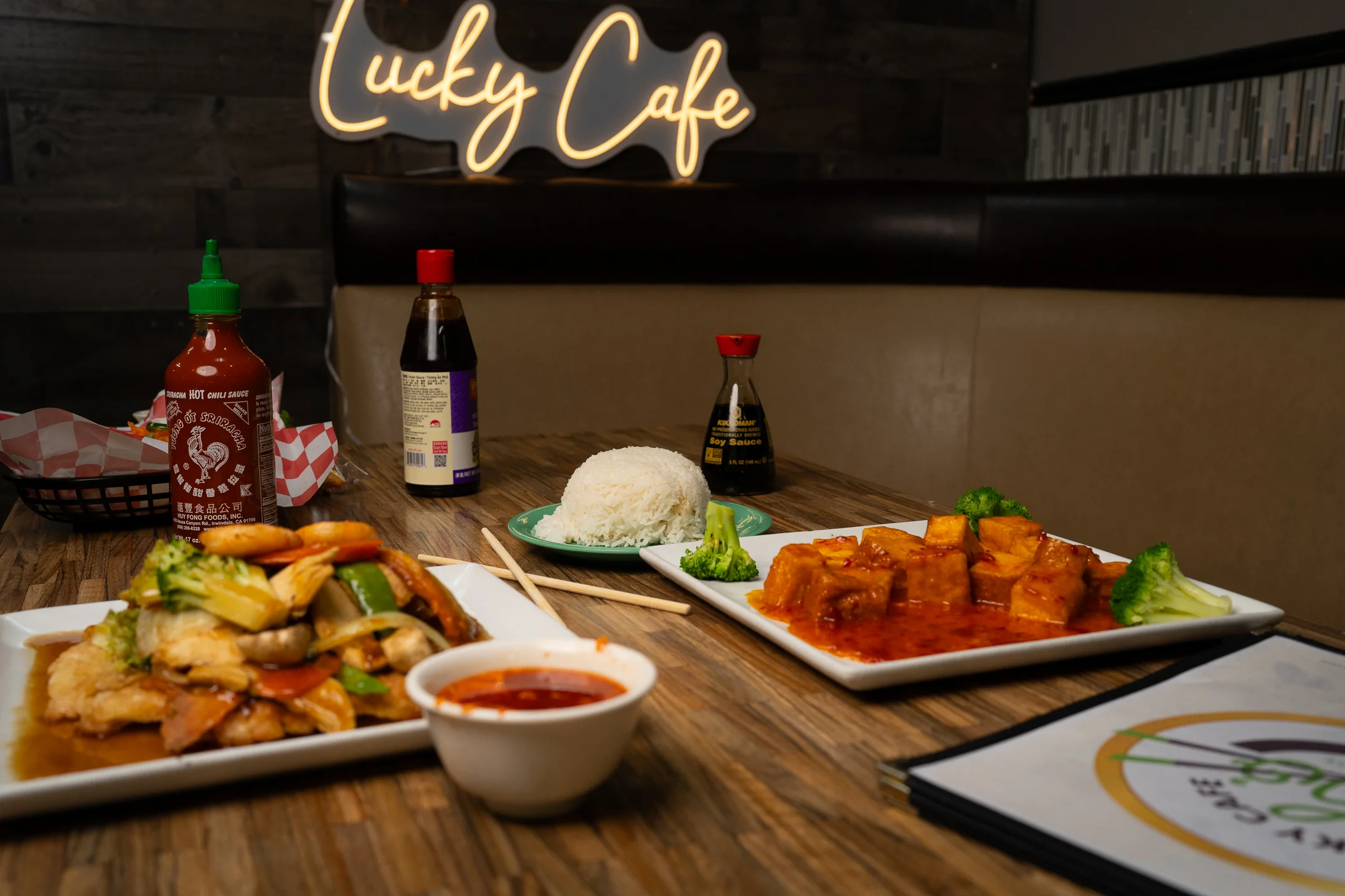 Chinese stir-fried vegetables with rice and tofu in a cozy cafe setting