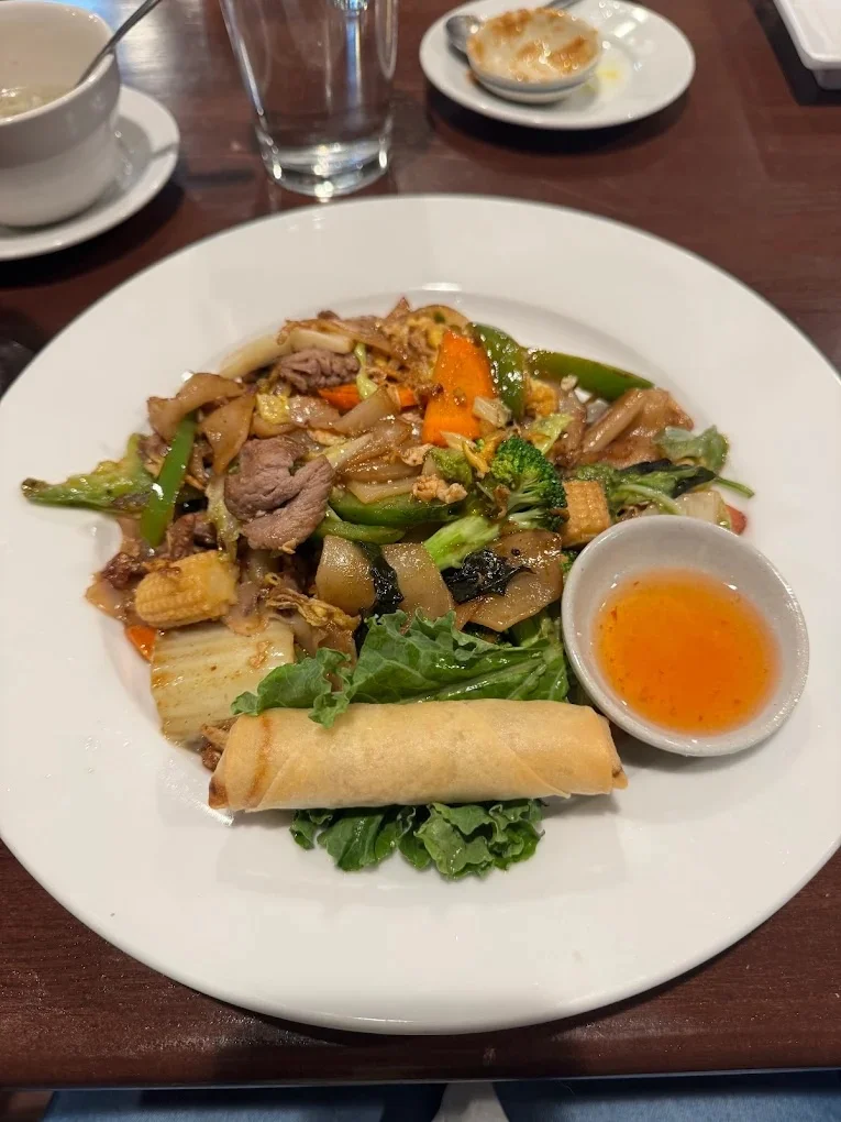Stir-fried Thai pad see ew with vegetables and spring roll