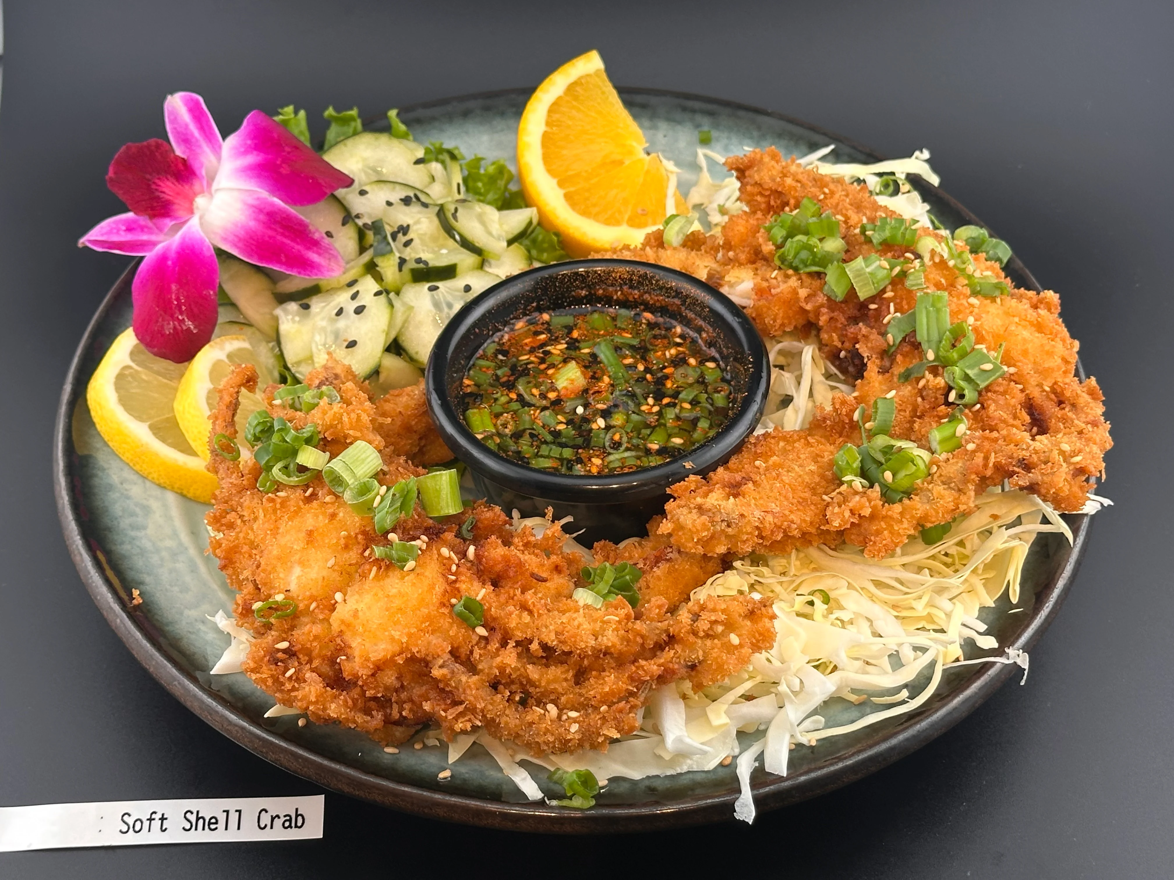 Crispy soft shell crab served with dipping sauce and garnishes