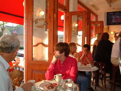 Cozy restaurant interior with wooden doors and warm lighting