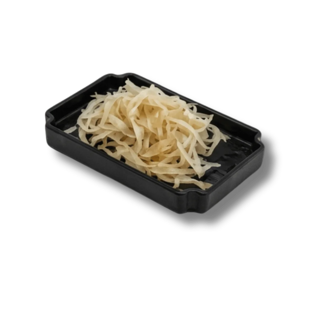 Plate of thinly sliced white vegetables on a black tray.