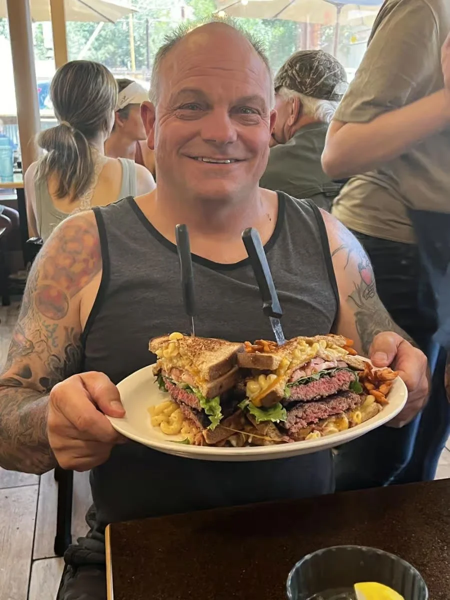 Giant burger sandwich with fries in a casual dining setting