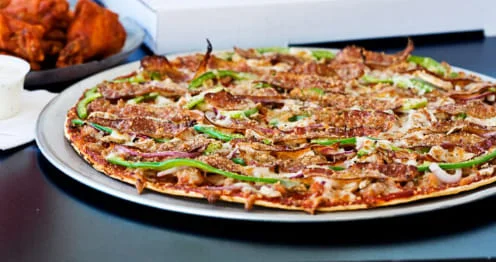 Delicious meat lover's pizza with green peppers and onions