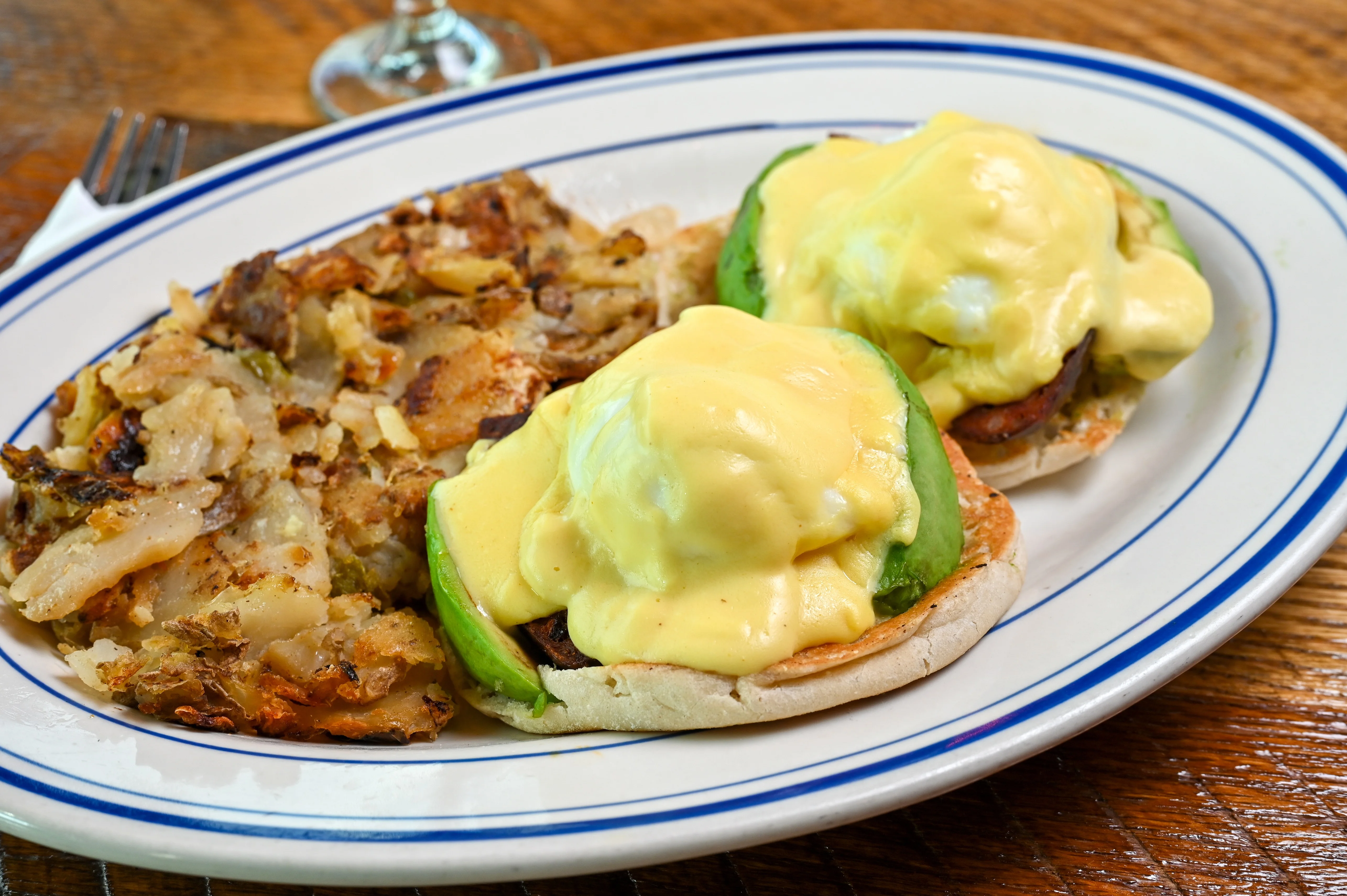Eggs Benedict served with crispy hash browns