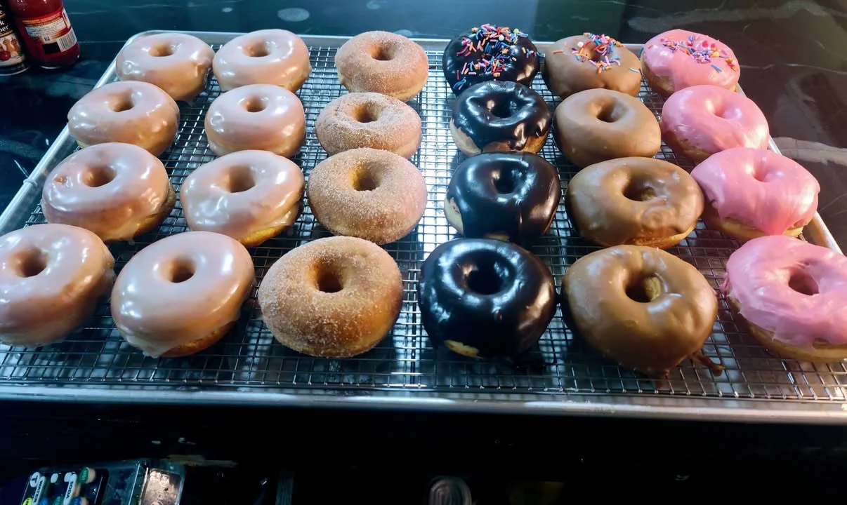 Assorted donuts including glazed, chocolate, and sprinkles