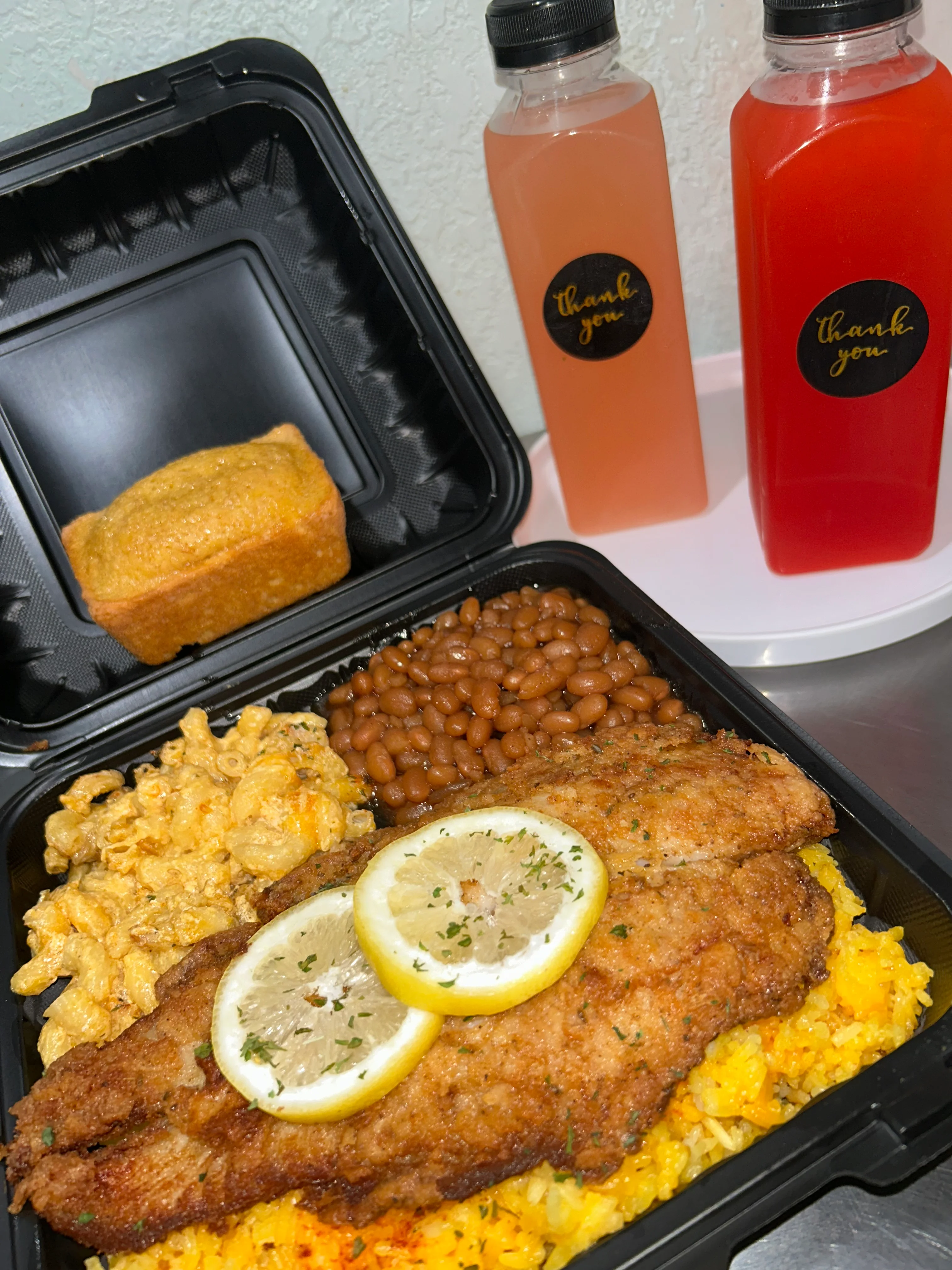 Southern fried catfish with sides in a takeout container