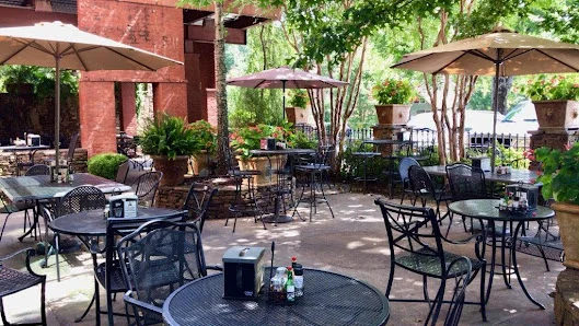 Charming outdoor dining area with umbrellas and greenery