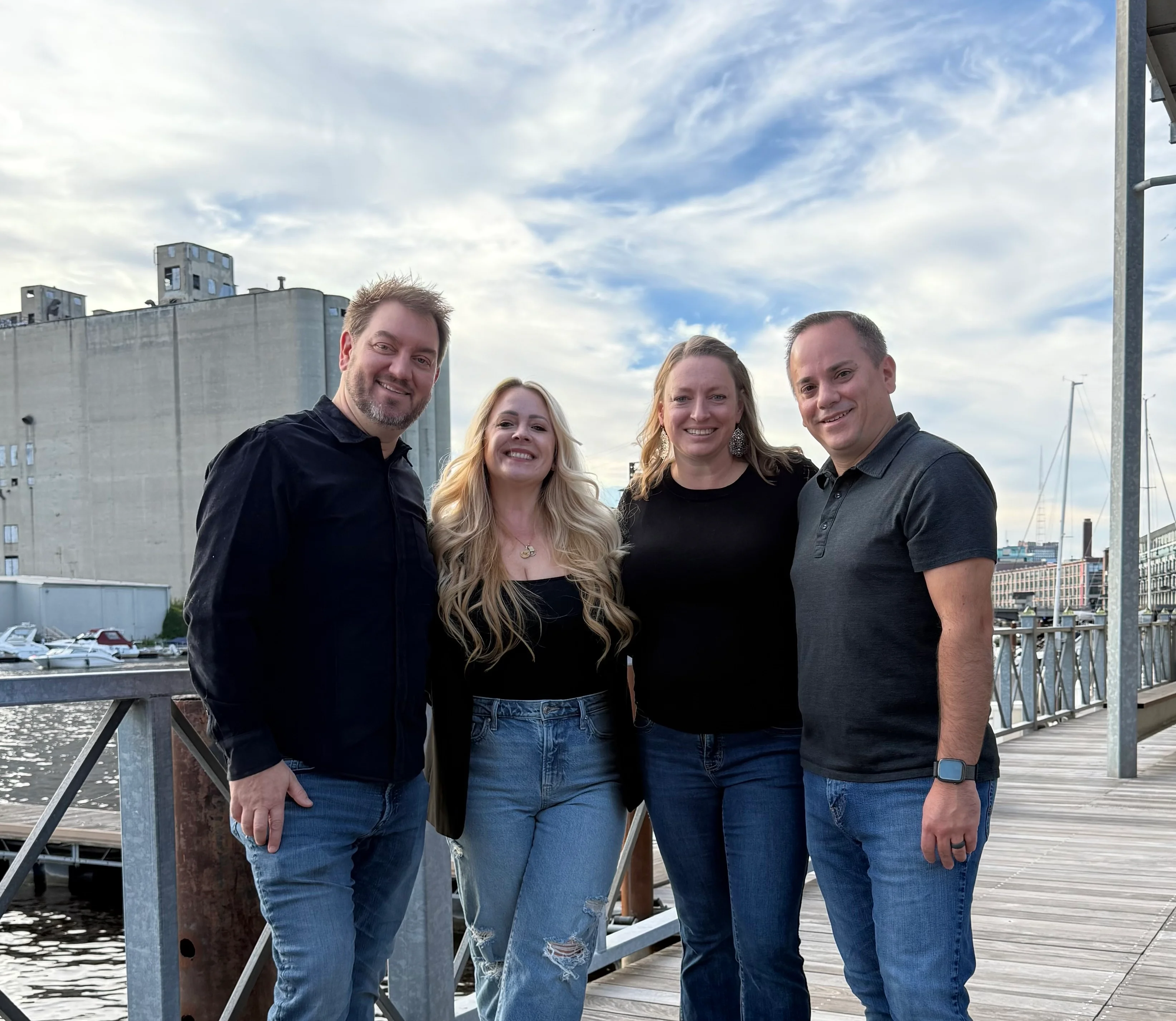 Group of friends posing by the waterfront on a sunny day