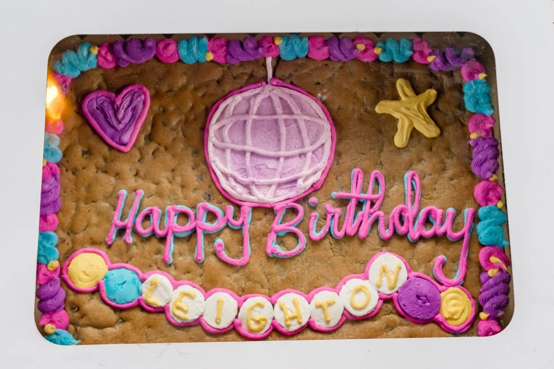 Colorful birthday cookie cake with decorative icing and festive designs