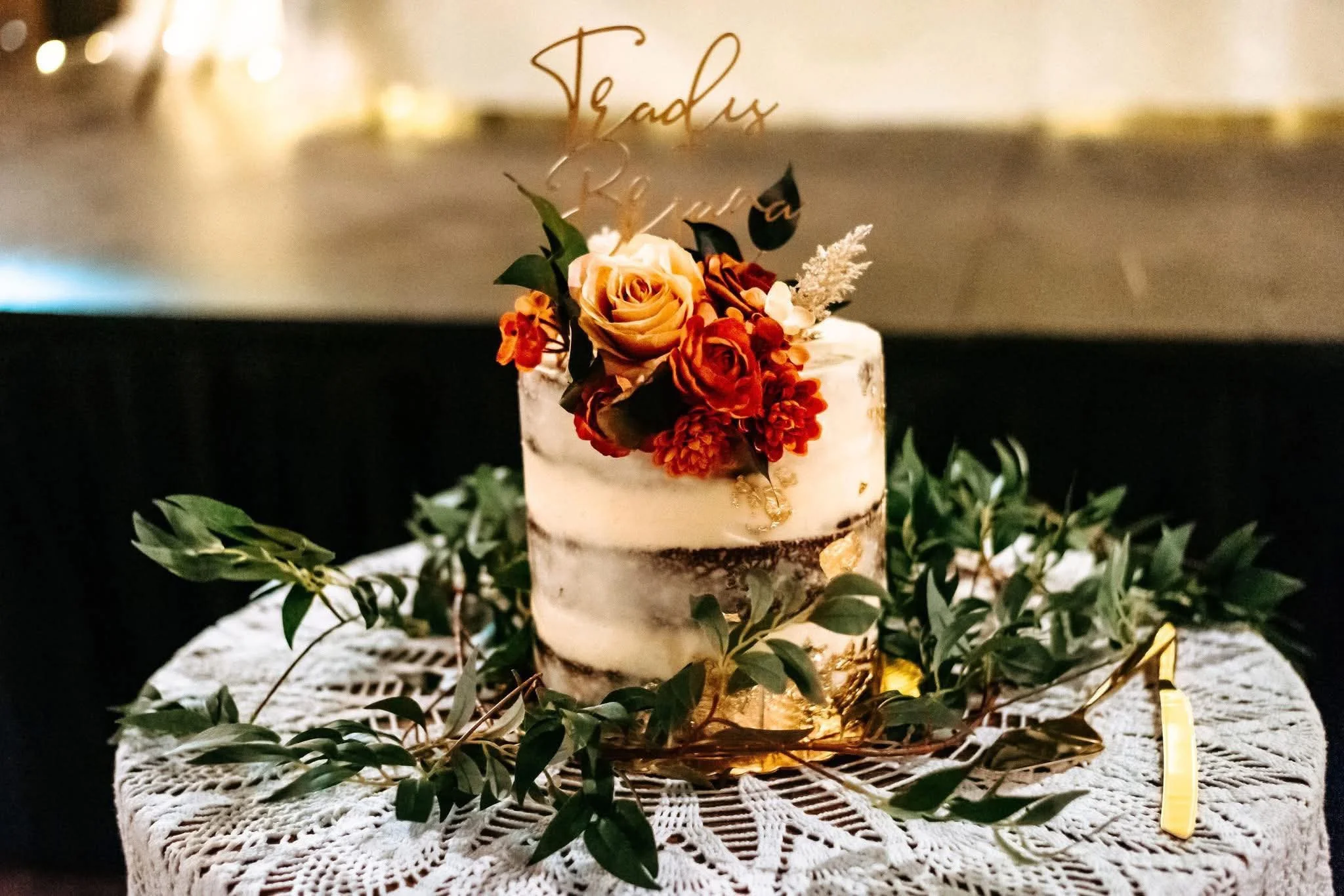 Elegant wedding cake adorned with flowers and greenery