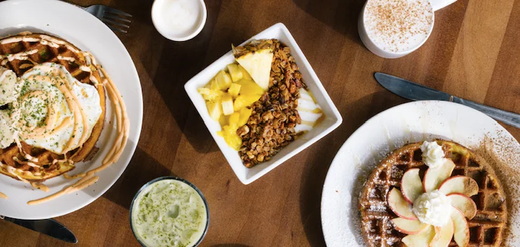 Delicious brunch spread featuring waffles and granola